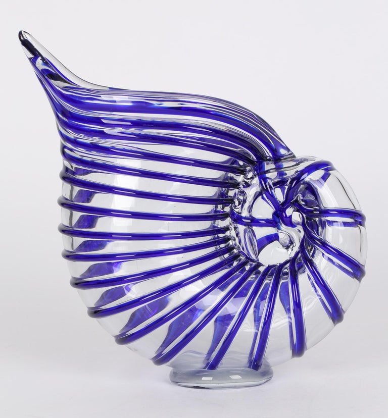 A stunning Italian nautilus shell shaped art glass vase with blue piping made in Murano and probably dating from around 1960/70. The design was probably inspired by Ercole Barovier who created a similar design in 1937. The large glass vase stands on