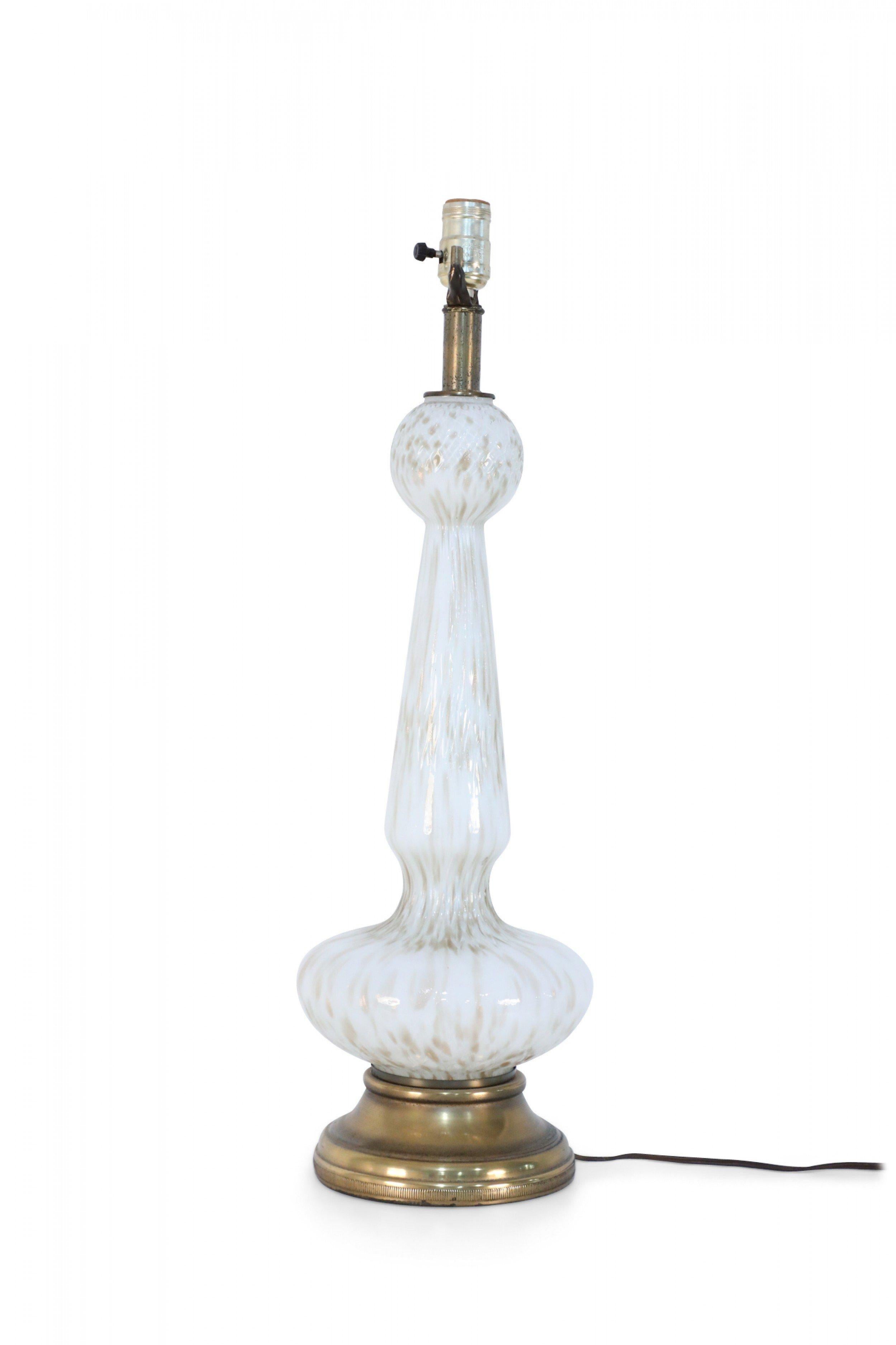 Italian Mid-Century Venetian-style white glass table lamp with gold dust streaks throughout on a circular brass base with brass fixtures.
    