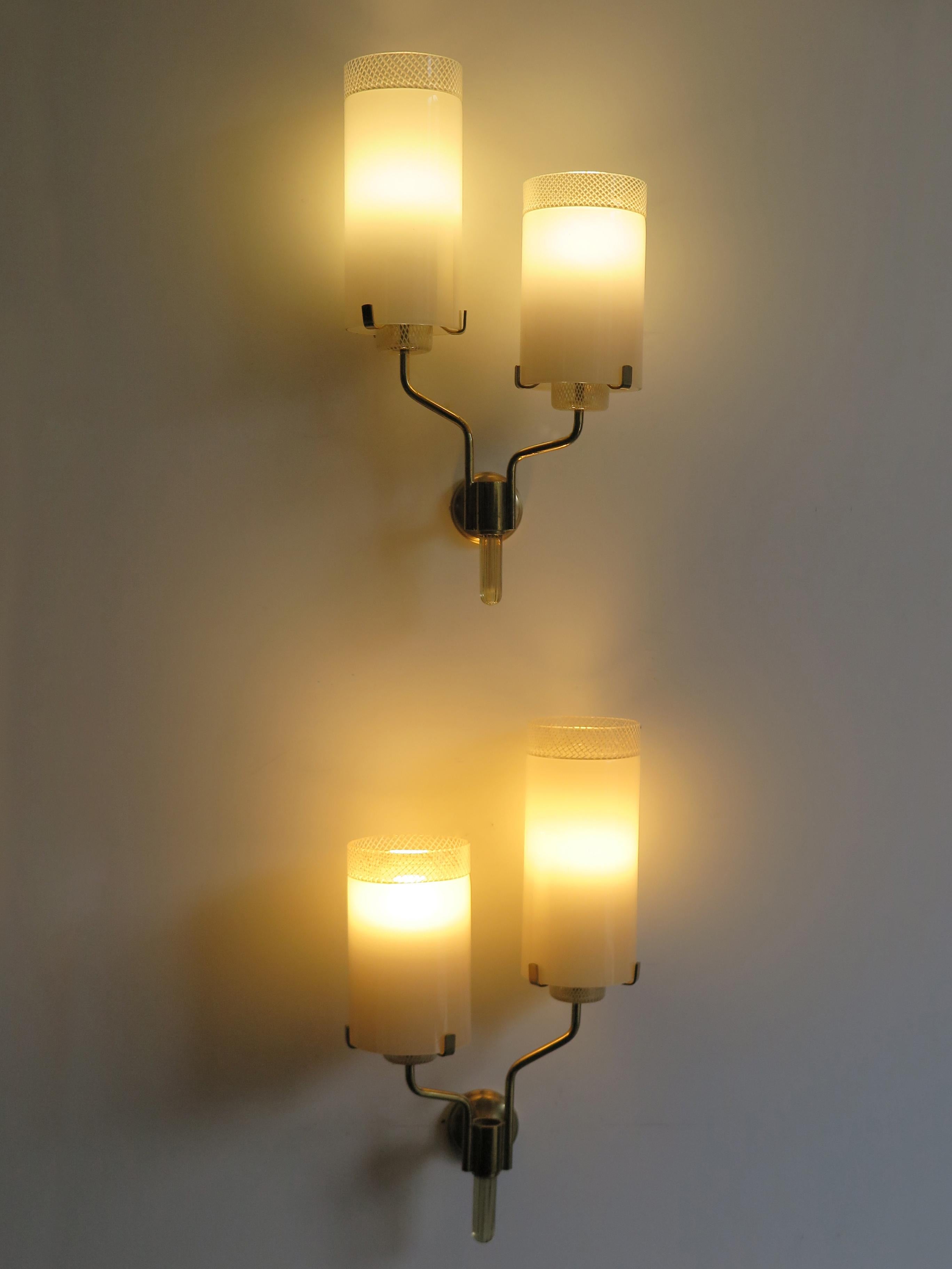 Italian Mid-Century Modern design sconces wall lamps with Murano glass diffusers, brass frame and thick glass detail, 1950s.
Please note that the lamps are original of the period and this shows normal signs of age and use.