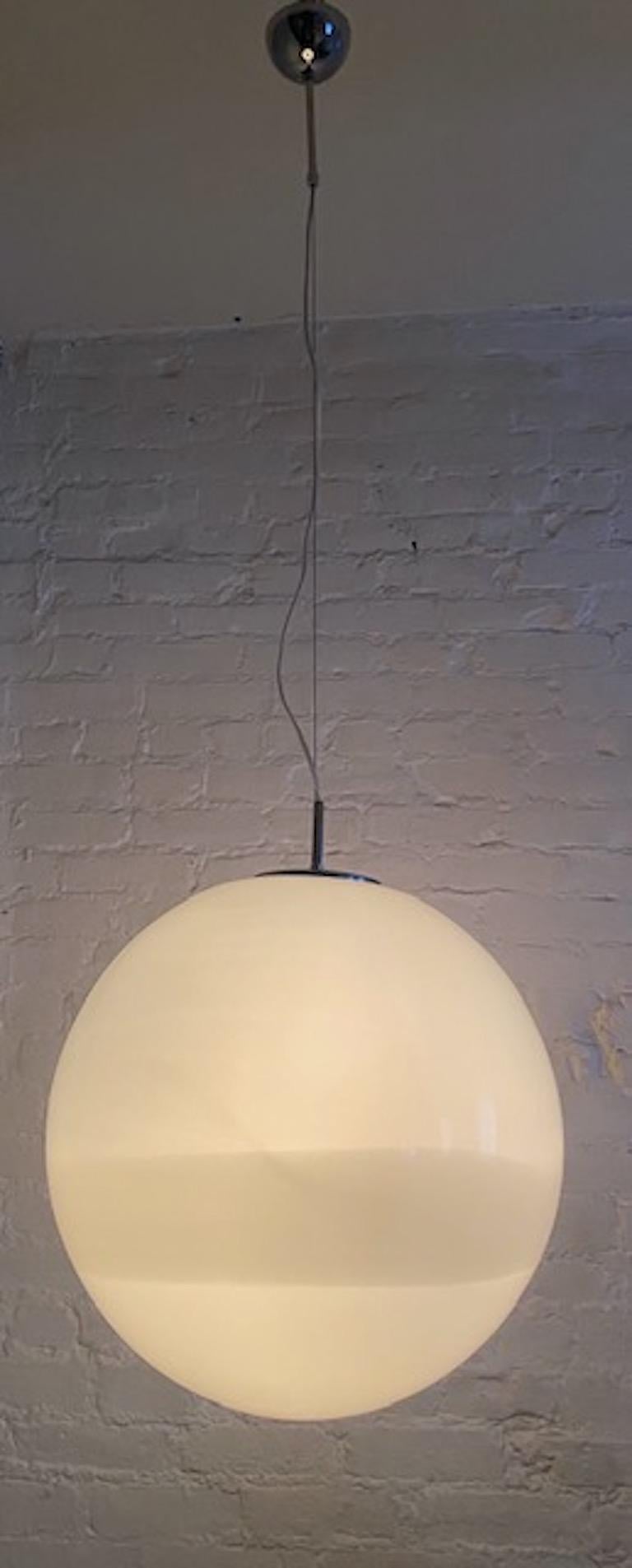 A 1970s large glass globe pendant from Murano, Italy. Hand blown 18 inch diameter opaque white glass globe with wide white stripe along the bottom third. Original chrome mount with 3 inch rod on top making total height of pendant 21 inches. Globe is