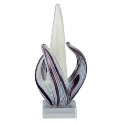 Murano, Italy. Art glass sculpture in purple and white glass on clear glass base