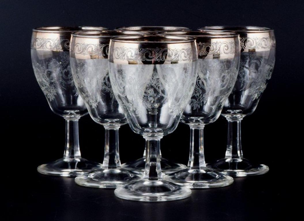 Murano, Italy, six mouth-blown and engraved port wine glasses with silver rim.
Mid-20th century.
In perfect condition.
Dimensions: H 12.2 x 10.0 cm.



