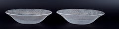 Murano, Italy, two bowls in clear glass with spiral-shaped gold decoration.