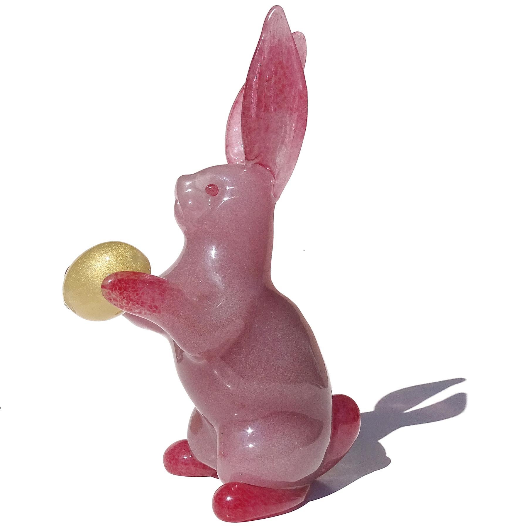 Beautiful and very large, vintage Murano hand blown pink bubbles and golden egg Italian art glass Easter Bunny rabbit sculpture. The rabbit is very nicely detailed with a cute face, big ears and it is holding an egg. The body is made in the