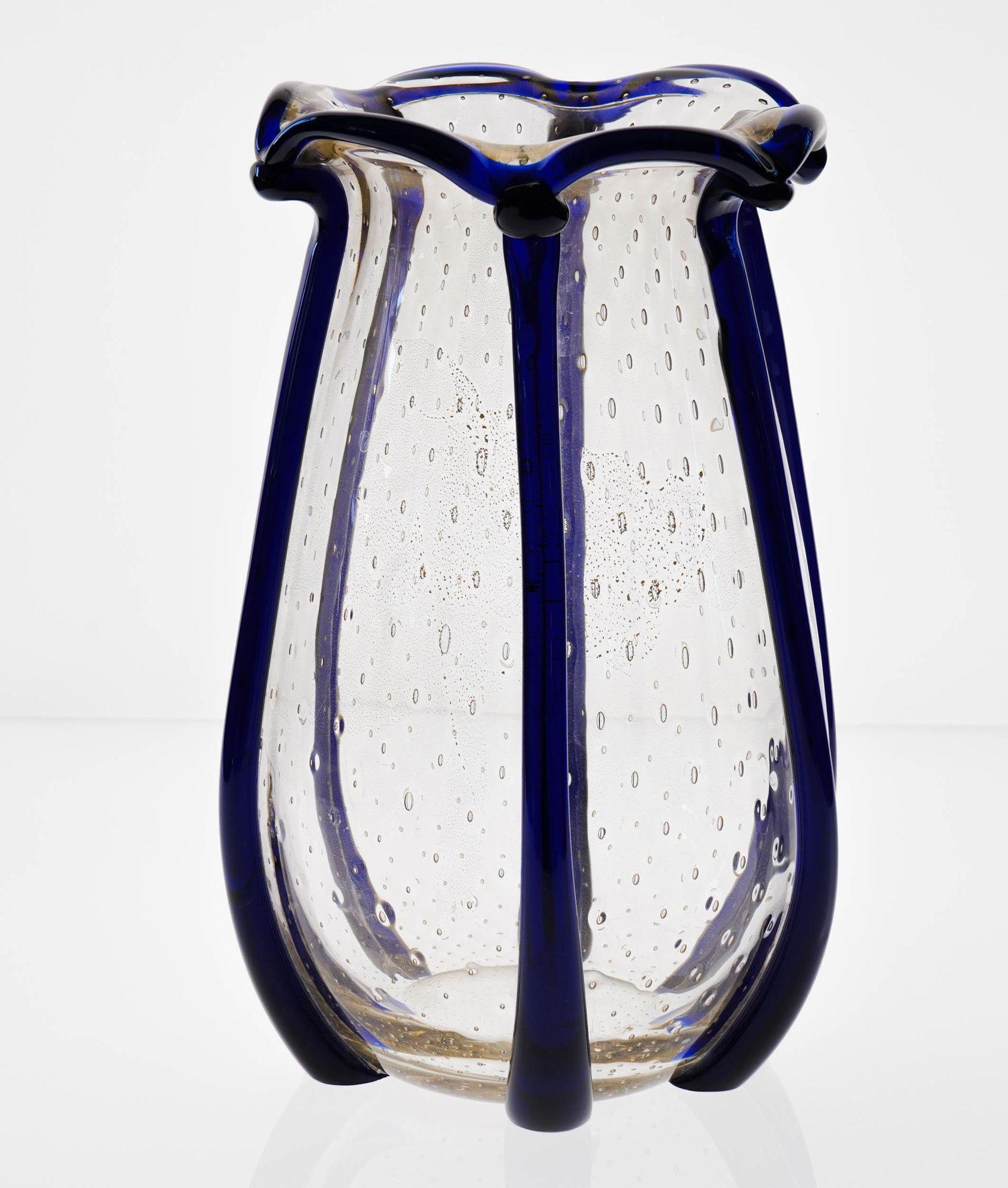 Large Murano Vase with vertical beads in Cobalt blue and baloton regularily spread bubbles in the clear part.
The clear part carries 24K gold leaf that is printed with baloton (a pine cone shaped mould used in Murano to create evenly spread bubble