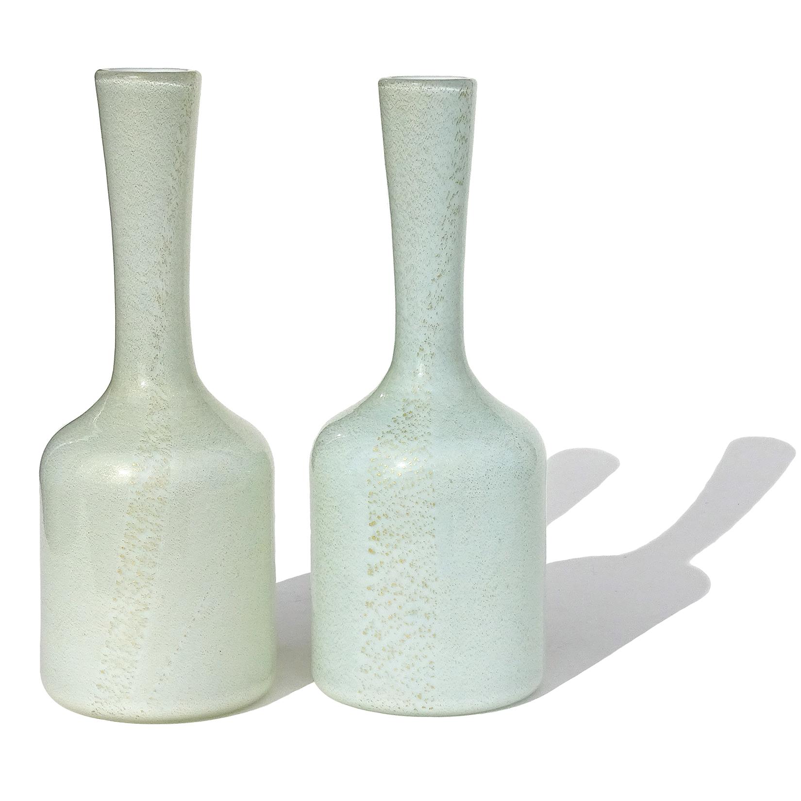 Beautiful vintage Murano hand blown, very light sea foam green and sea foam blue colors Italian art glass flower vases. Both vases have the same shape and size. They are profusely covered in gold leaf throughout the surface. They vases are created