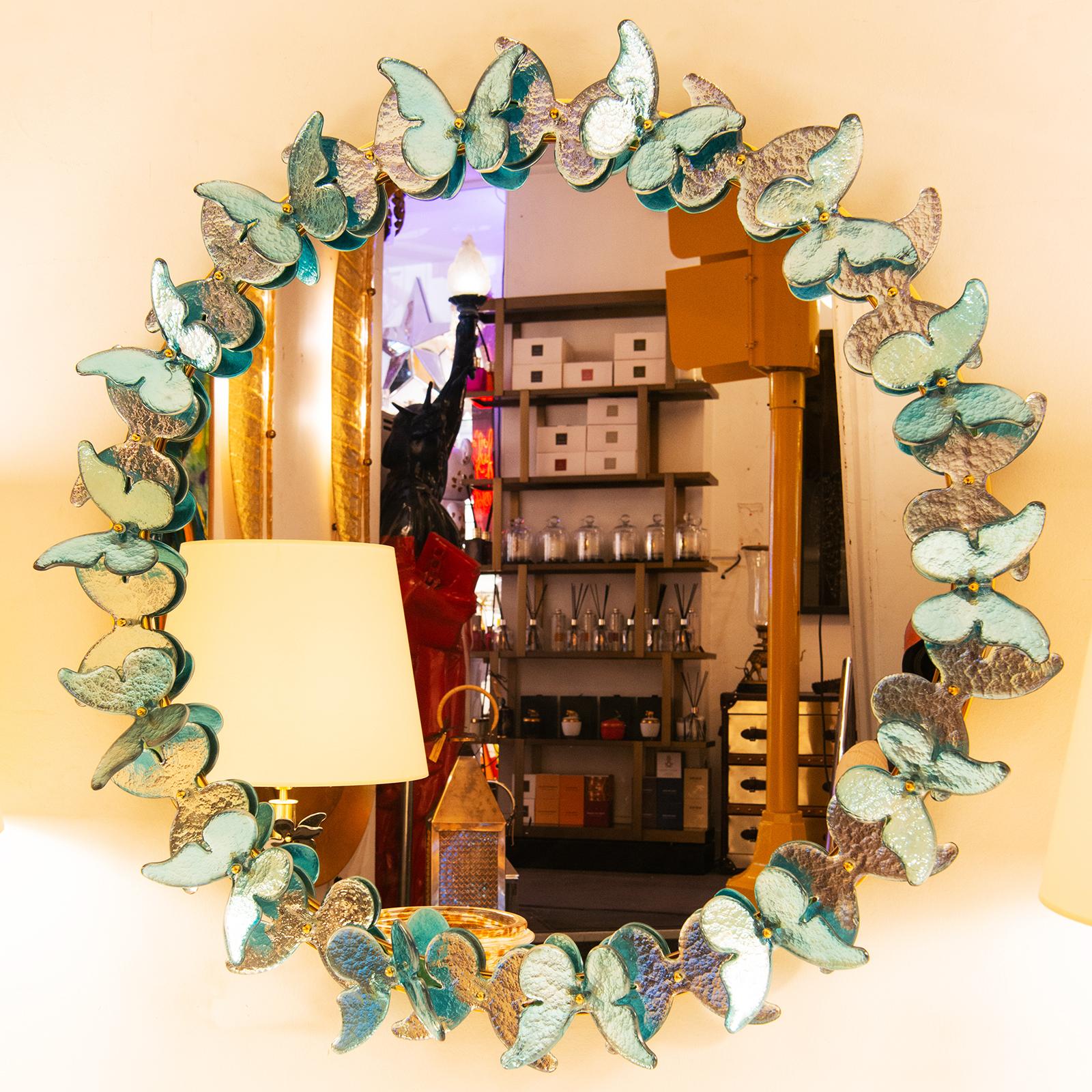 Mirror Murano Light Blue Butterflies with center flat
mirror glass and with frame ornamented with deep 
blue murano glass butterflies with silver leaf taken 
under the murano glass. 
Exceptional and unique piece.