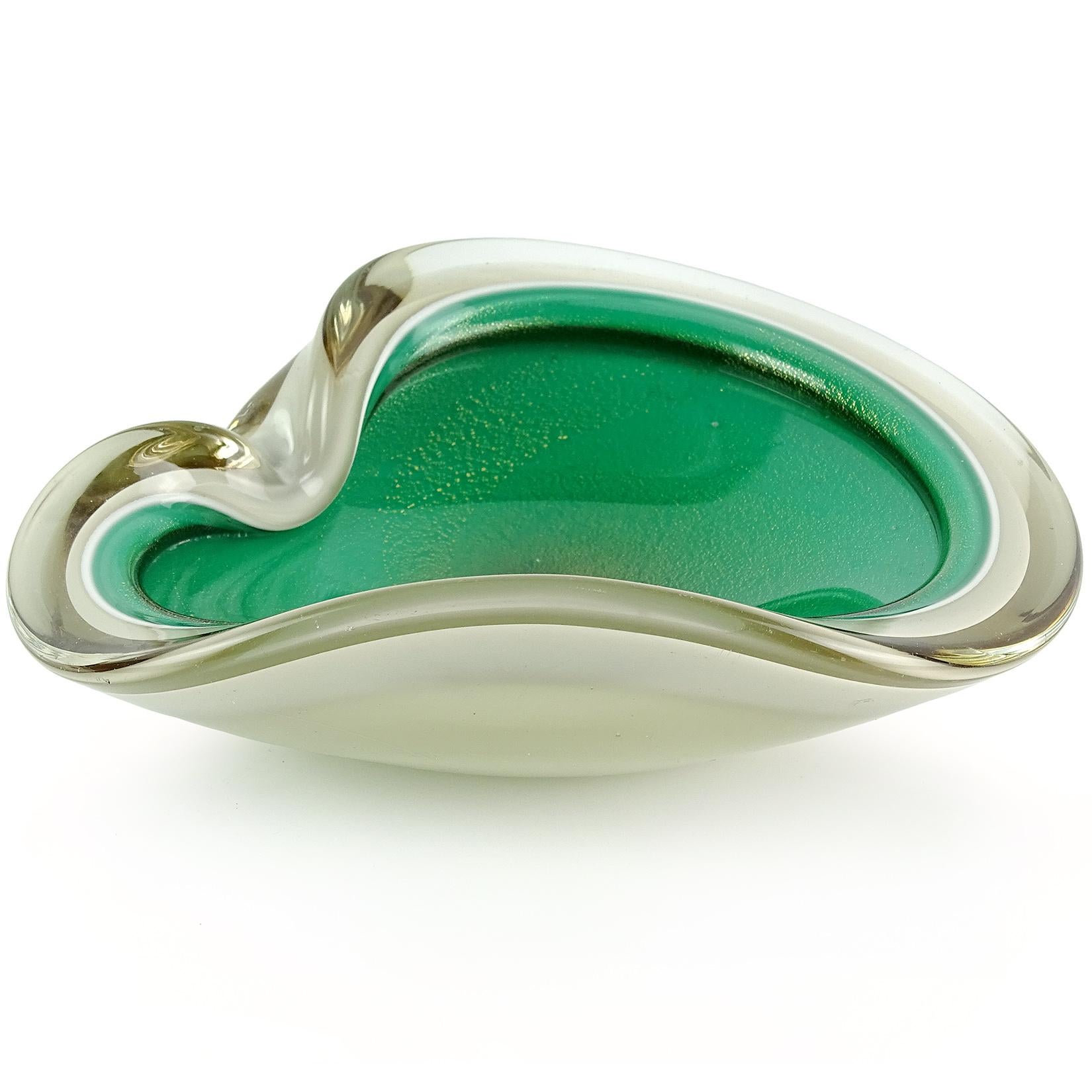Beautiful Murano hand blown light tan / taupe over green and gold flecks Italian art glass decorative bowl. Made with 4 layers, with clear layer outside, and white layer between the colors. It has a folded over rim, and indent on the side. The bowl