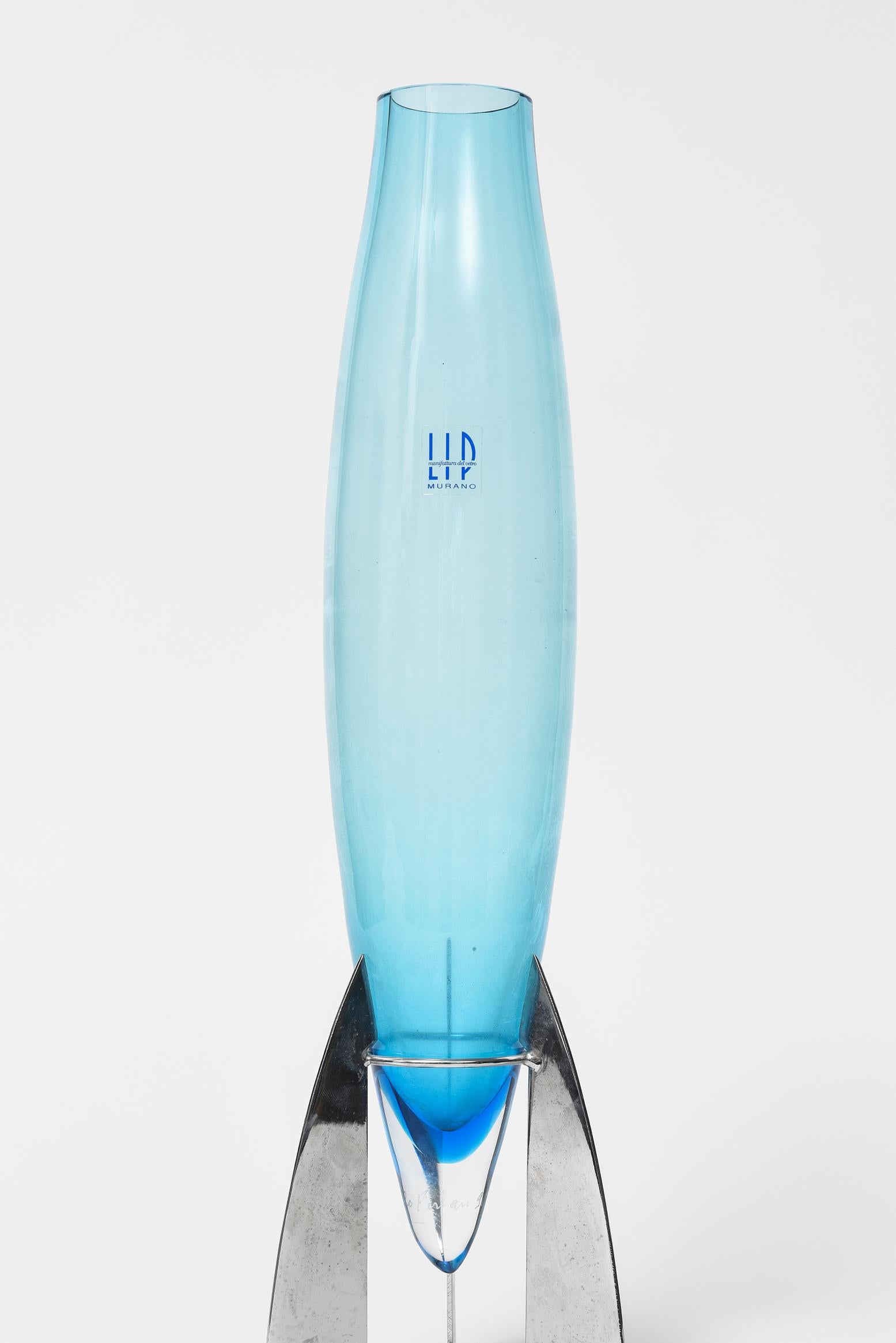 Marcello Furlan LIP Manifattura del Vetro blue murano Italian vase with chrome metal stand. The vase looks like a industrial rocket ship.

It has the original sticker tag LIP manifattura del vetro vase and is etched signed on the bottom.