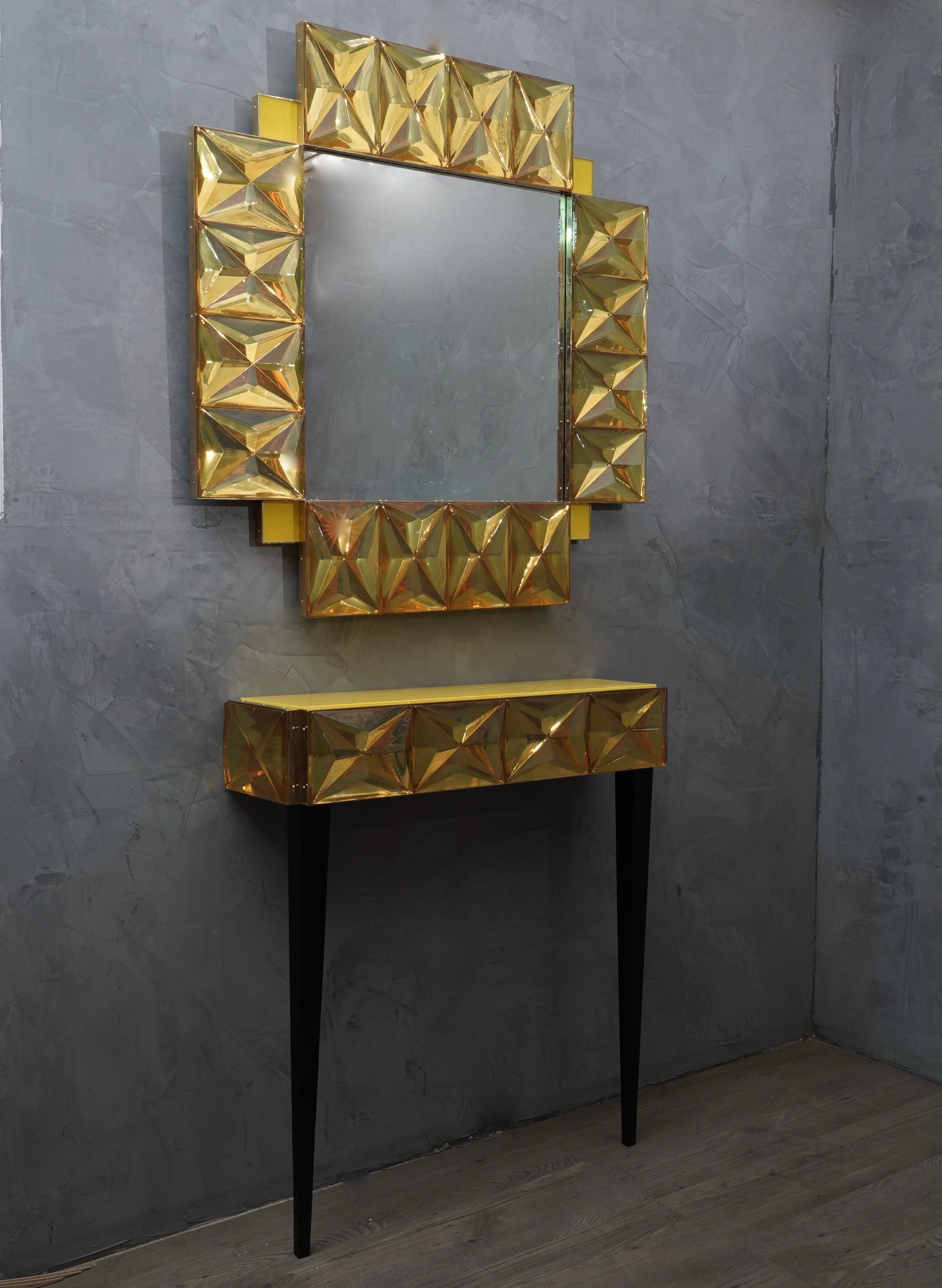 A strong yellow frame, reach the eye of the beholder, leaving him entranced; of Murano yellow art glass wall mirror. 

The structure of the wall mirror is in wood, where the yellow Murano glass is housed. The frame of the mirror is made up of a