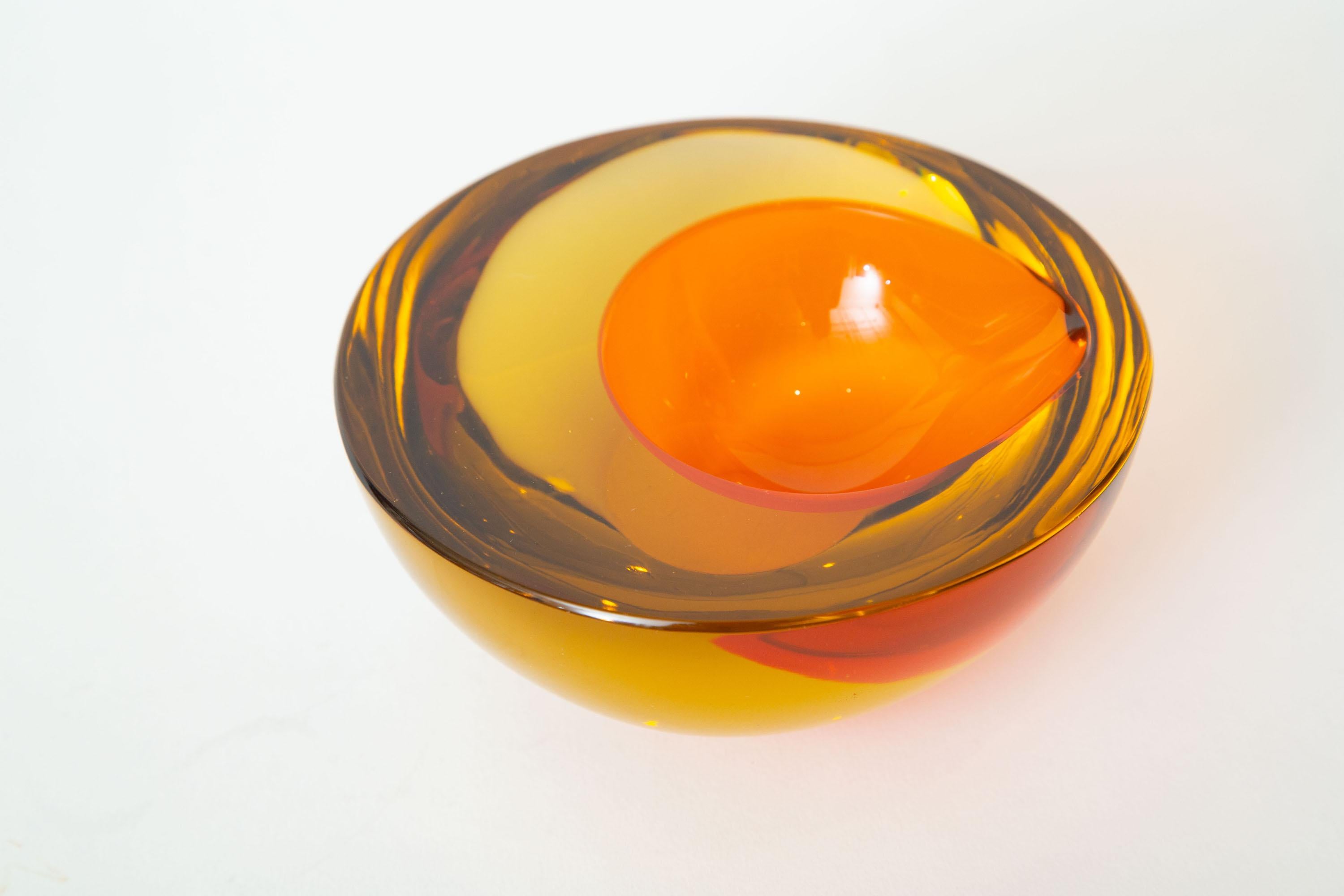This thick and fabulous vintage Murano orange and yellow amber glass geode bowl is the work of Allessandro Mandruzzato. It is almost like an orange egg lies in the center. It is Sommerso glass. From the 1970s. Could be used as a decorative bowl or