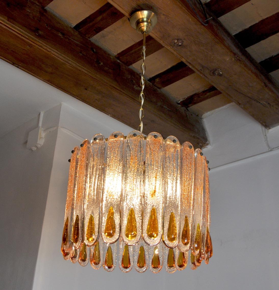 Rare and imposing murano mazzege chandelier designed and produced in murano, italy in the 60s. Golden metal structure composed of murano glass crystals, orange and frosted, in perfect condition, distributed in a circle. Unique design object that