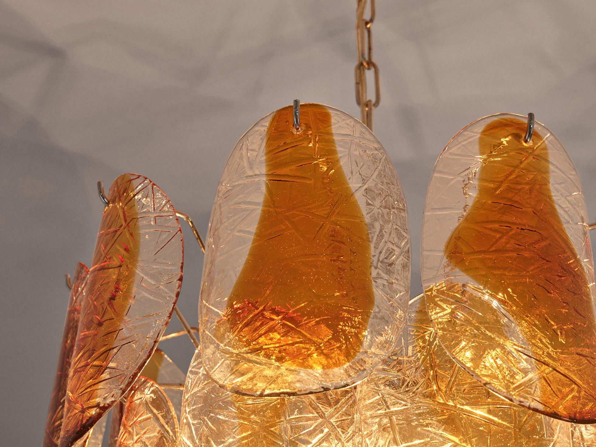 Murano chandelier with stained yellow glass and brass, Italy, 1960s. 

This Murano chandelier which emanates warm light, is made by loose organic glass leaves. The glass is in 'Mazzega' style with a bubbly pattern and look like they are dipped in