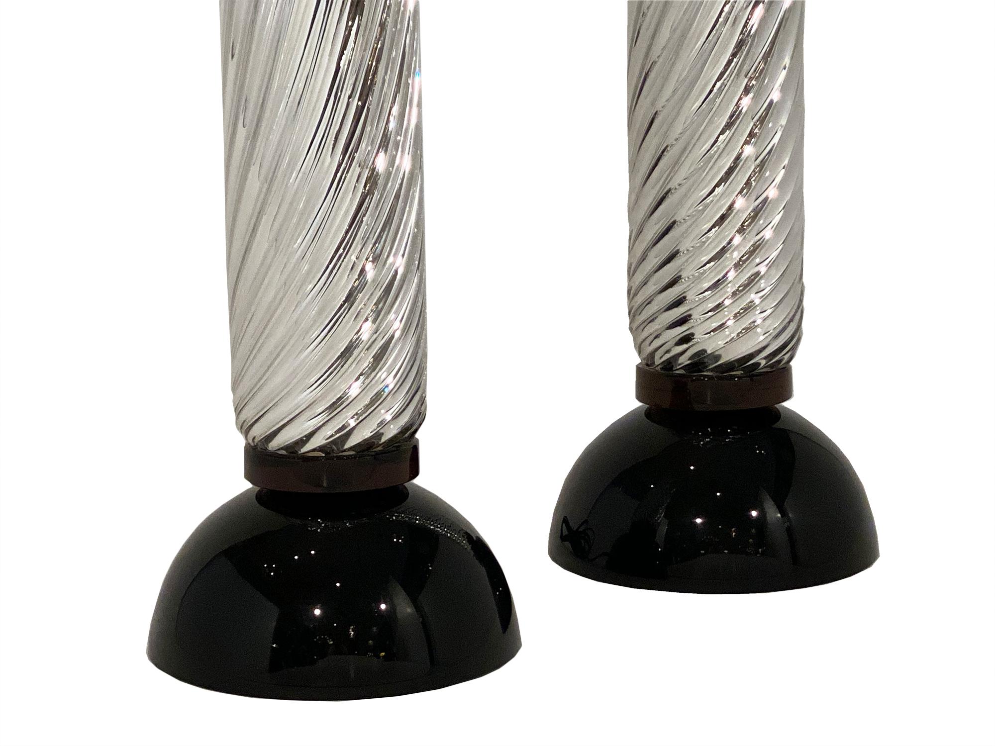 Murano mercury glass spiral lamps from Italy. This hand blown pair of “vetro specchiato” mercury glass lamps have a black glass base and a beautiful curving pattern. They have been newly wired to fit US standards.