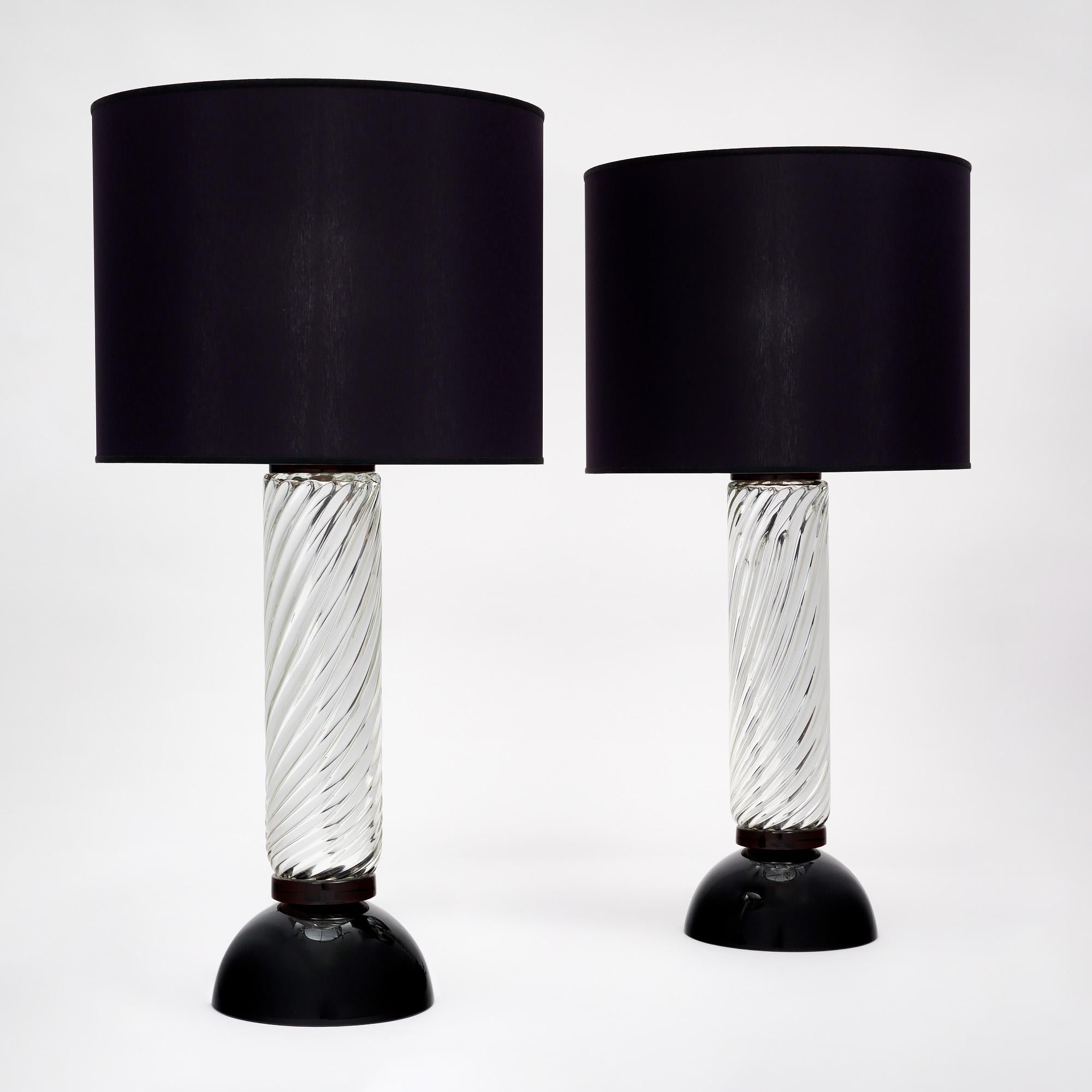 Murano mercury glass spiral lamps from Italy. This hand-blown pair of “vetro specchiato” mercury glass lamps have a black glass base and a beautiful curving pattern. They have been newly wired to fit US standards. They are in very nice condition.