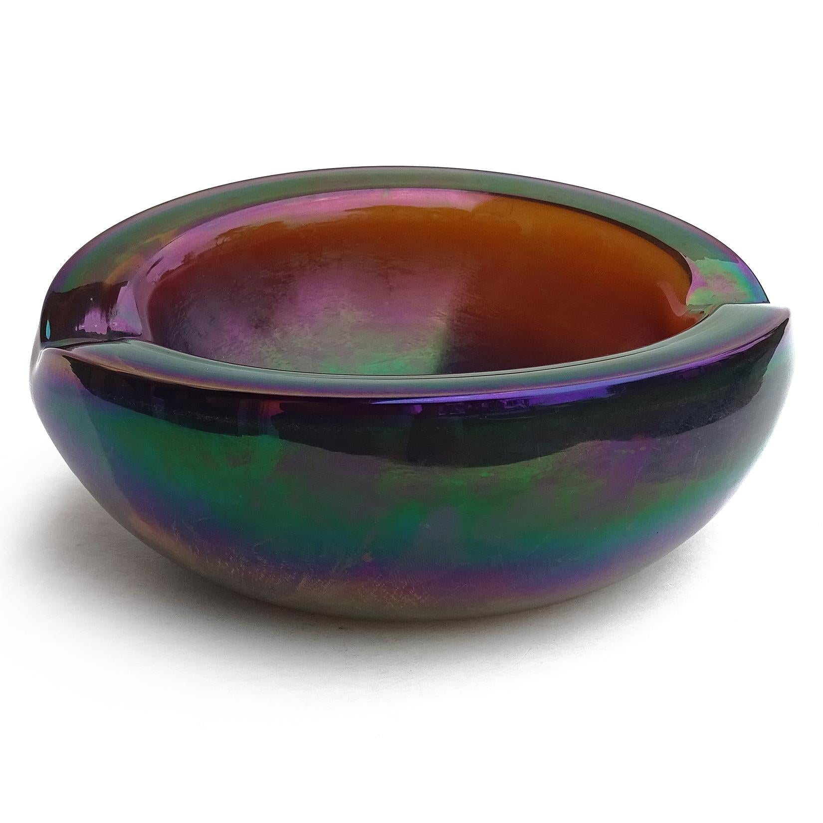 Beautiful and unusual Murano hand blown dark high gloss iridescent / aurene Italian art glass bowl. The piece is made with thick glass, and shows a rainbow of colors when the light hits. It has 2 indents on the rim, so could be used as an ashtray.