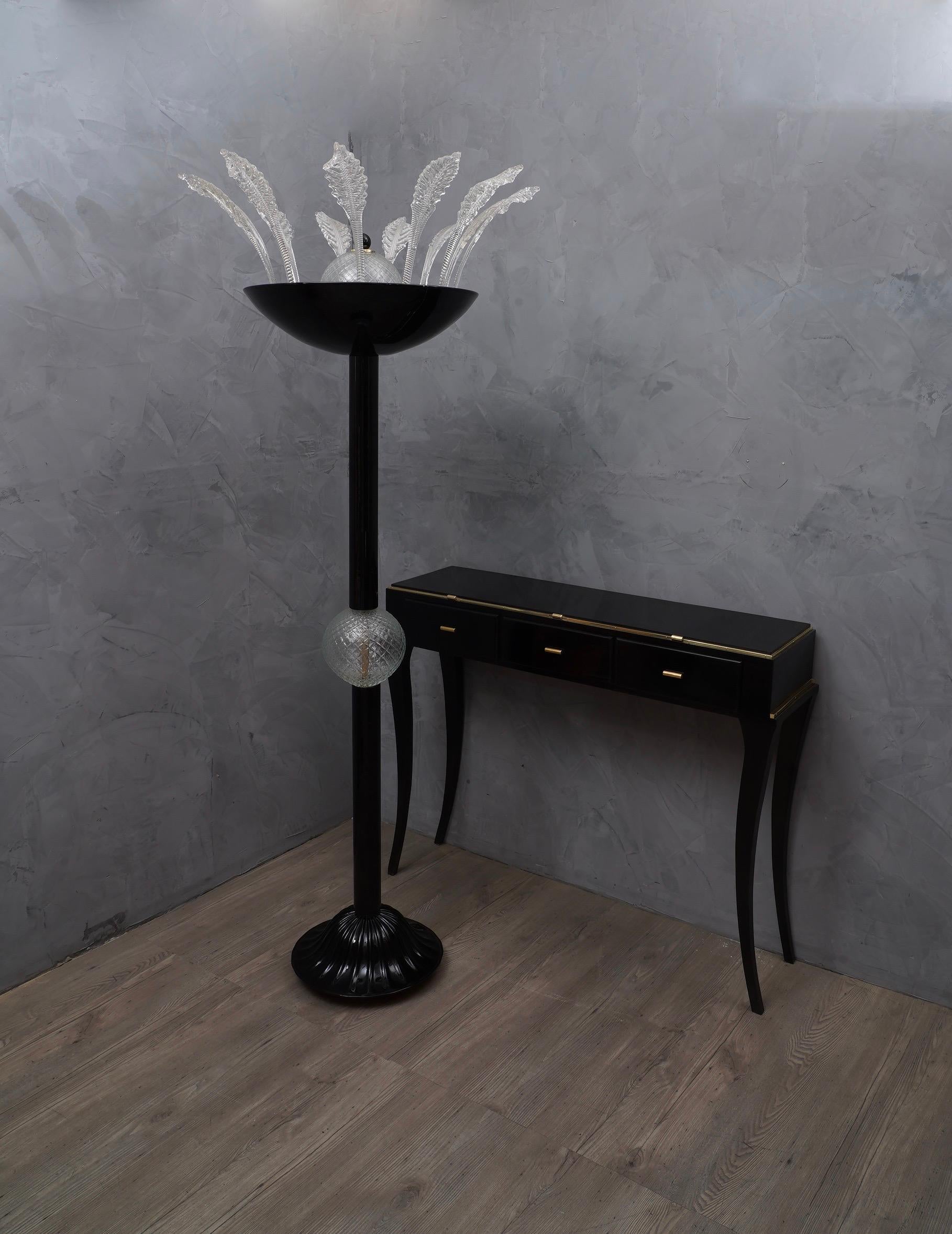 Very special black Murano glass floor lamp with transparent glass details.

The floor lamp has a metal core that acts as a structure, all glass pieces are mounted on it. It is composed of a base and a stem with a transparent sphere in the center,