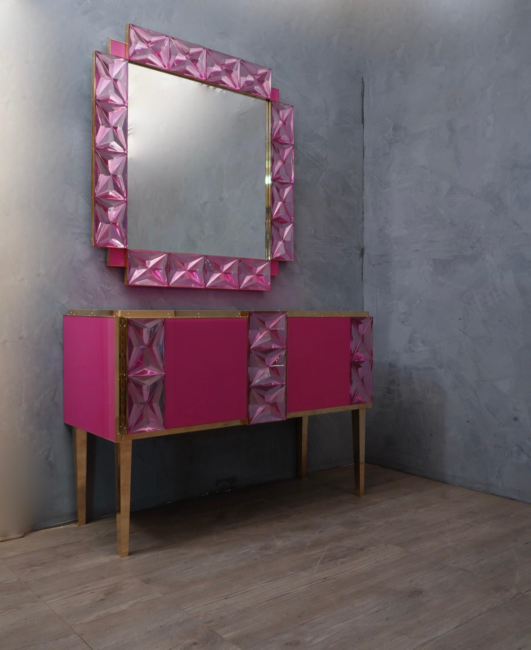 Stunning and unique sideboard all in pastel pink adorned with matching colored Murano glass bricks.

The sideboard has a wooden structure, then plated in pastel pink colored glass. Each side and each front has been edged with a brass finish. The
