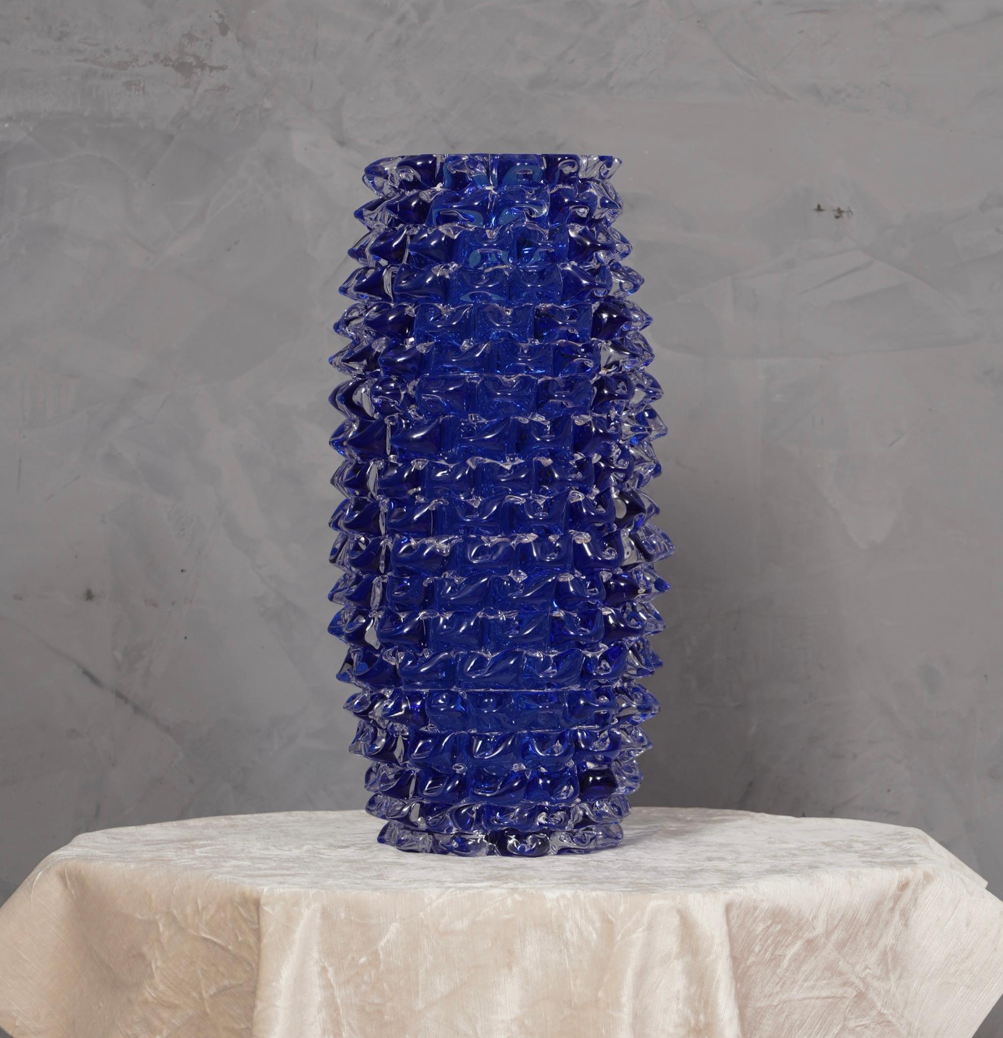 Fantastic vase from the Murano glassworks, both for its special processing and for its color, in fact the vase is blue color but has an internal transparent coating, called 
