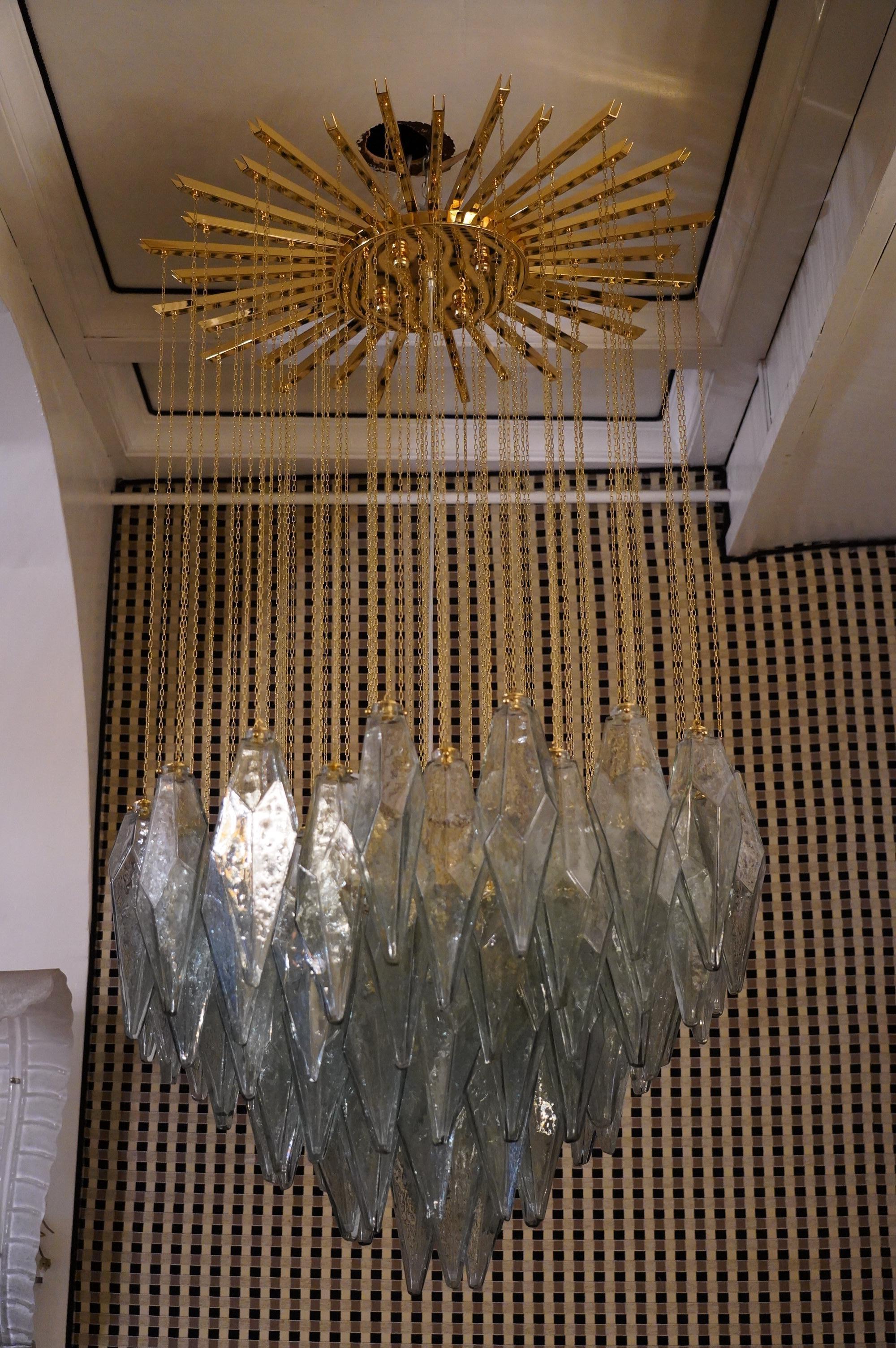 Stunning seawater blue Murano glass chandelier, exalting the asymmetrical shape of its polyhedron and also exalting the design of the chandelier, with this star attached to the ceiling from which the irregular polyhedra hang with chains.

The Murano