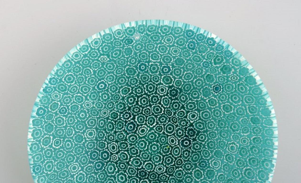 Murano Mille Fiori bowl in turquoise mouth-blown art glass. 
Italian design, 1960s.
Measures: 14 x 3 cm
In excellent condition.