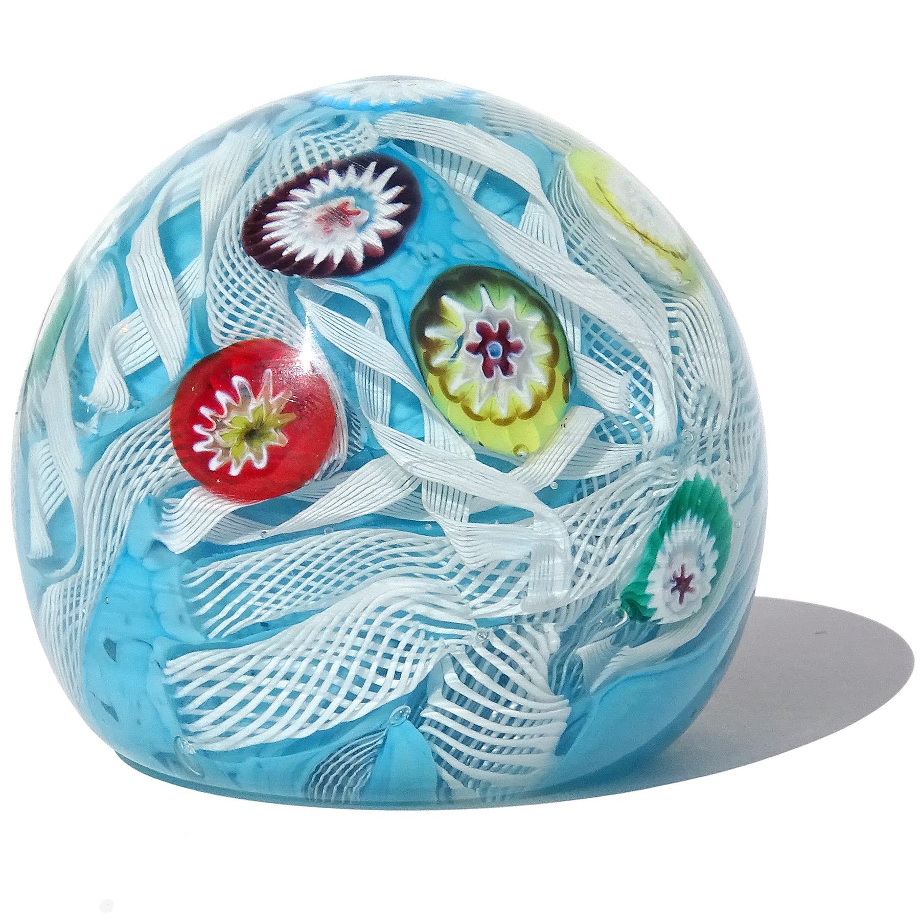 Beautiful vintage Murano hand blown blue, white and multicolor millefiori flowers Italian art glass paperweight. Documented to the Fratelli Toso company. It has 2 different white Zanfirico ribbon designs, embedded into the blue color spots making up