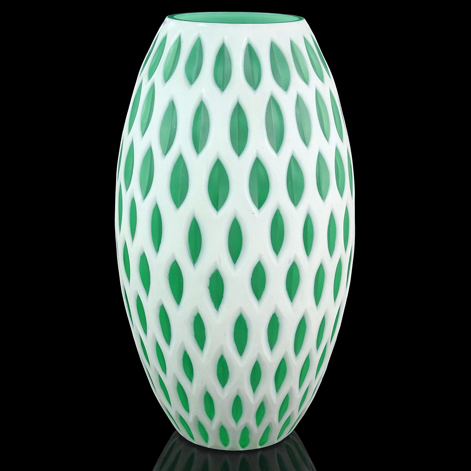 Large modern Murano hand blown white over green layers Italian art glass sculptural flower vase with carved surface. The carved ovals show the inner layer. Looks like an elegant bee hive. Measures: 12 7/8