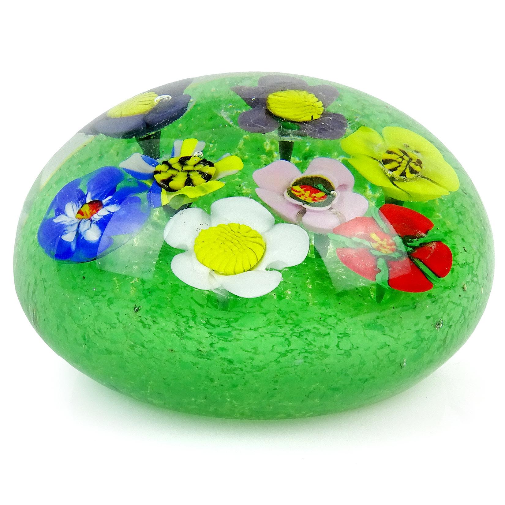 Gorgeous large vintage Murano hand blown millefiori wild flower garden Italian art glass paperweight. Each flower has a different color and pattern, and grow out of a green grass bed, made with little dots of color. Measures: 3 3/4