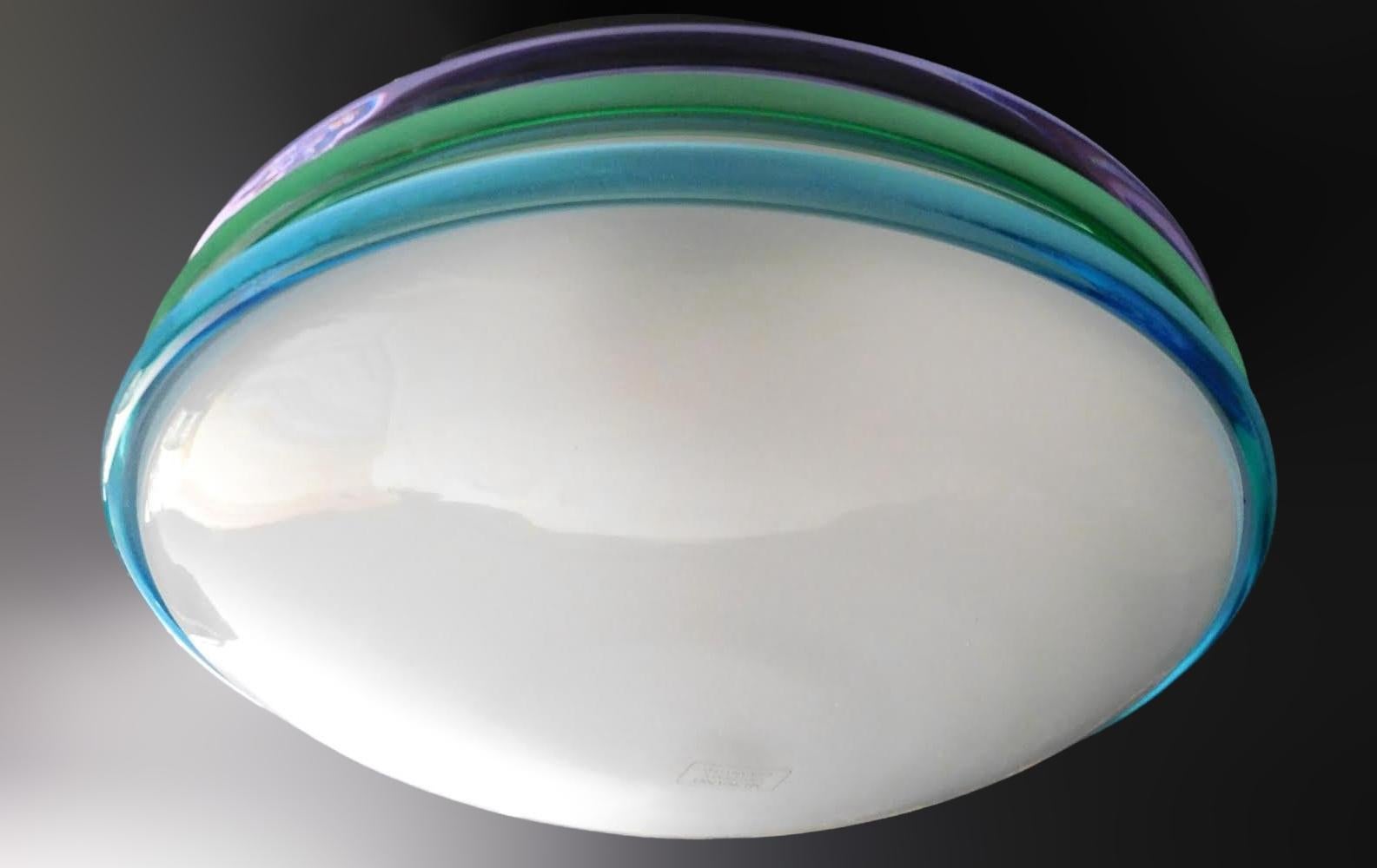 Vintage Italian flush mount or wall light with a frosted Murano glass shade decorated with blue green and purple ribbing / Made in Italy by Venini, circa 1960s
Measures: diameter 14 inches, height 5.5 inches
2 lights / E26 or E27 type / max 60W