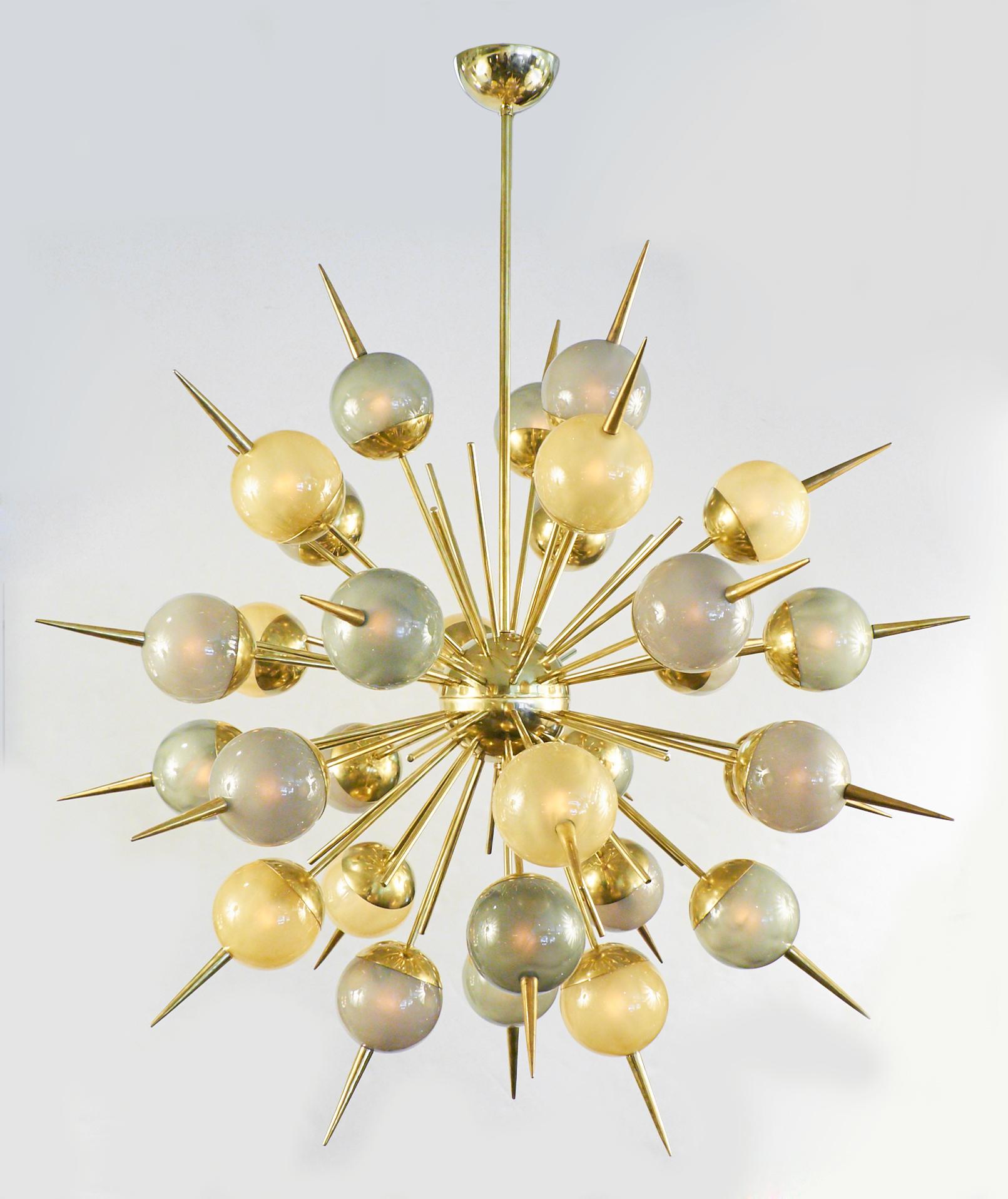 Mid-Century Modern style Murano glass and brass chandelier with an array of thirty globes in gold, green, and purple Murano glass on brass rods with spikes. Each globe is lit from within on this striking Sputnik style light fixture. Holds thirty