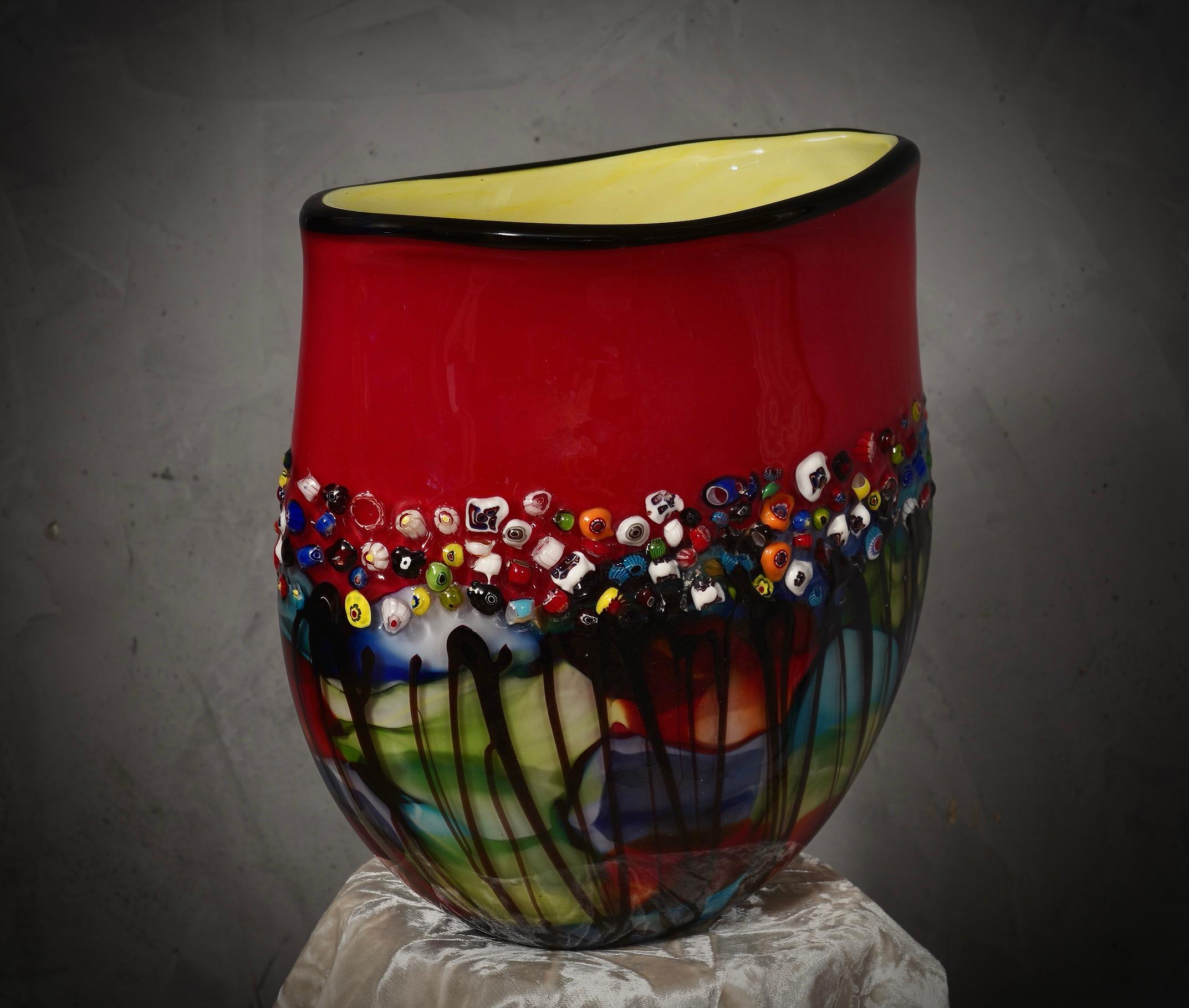 Fantastic vase from the Murano glassworks, both for its particular workmanship and for the colour, in fact the vase is red in color and has a green internal lining, called 