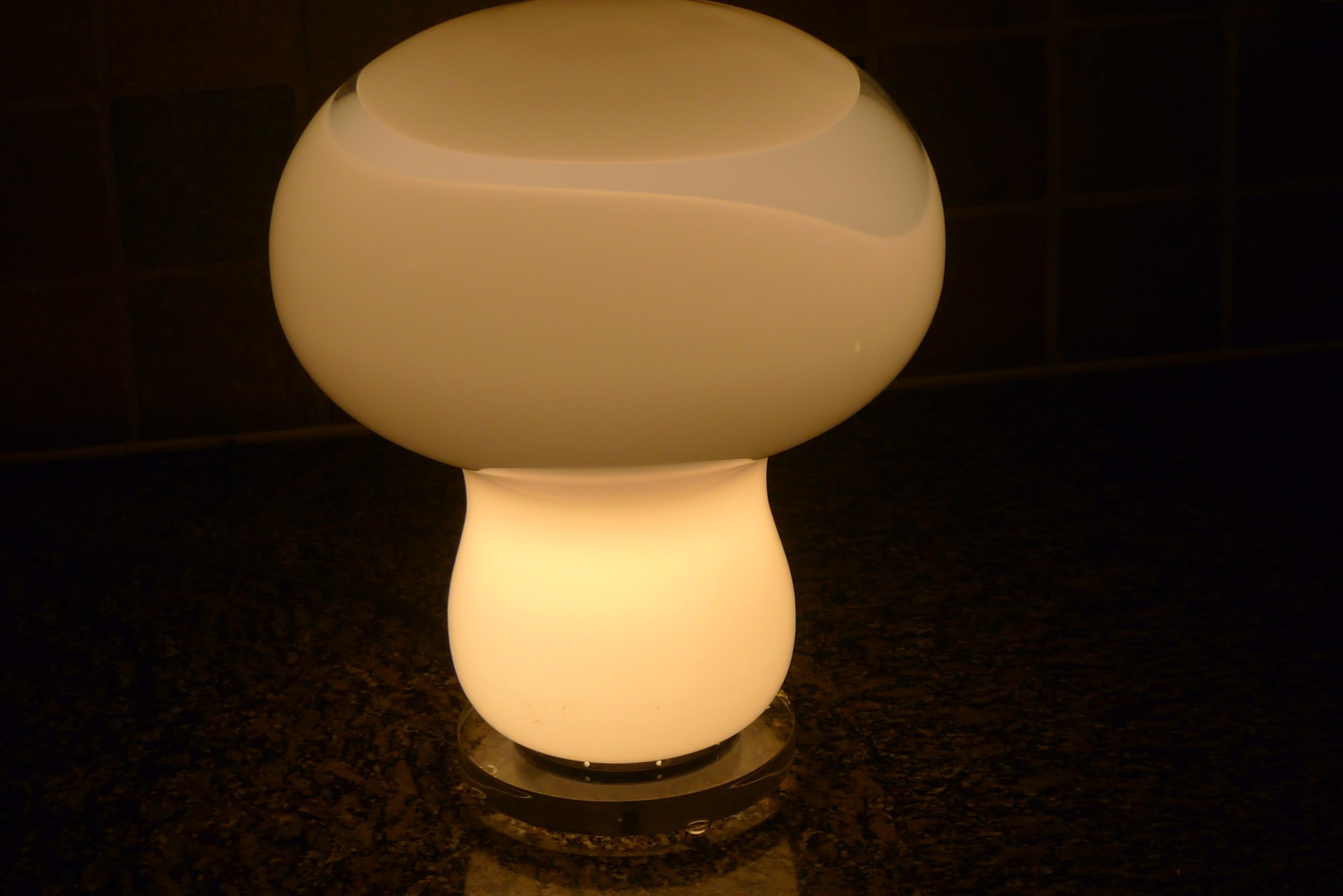 Murano mushroom table lamp by Gino Vistosi with clear glass swirl. Midcentury. Mounted on acrylic base with European in-line switch. Professionally wired with UL-approved components. Beautifully appointed lit or unlit. When lit, exudes soft, warm