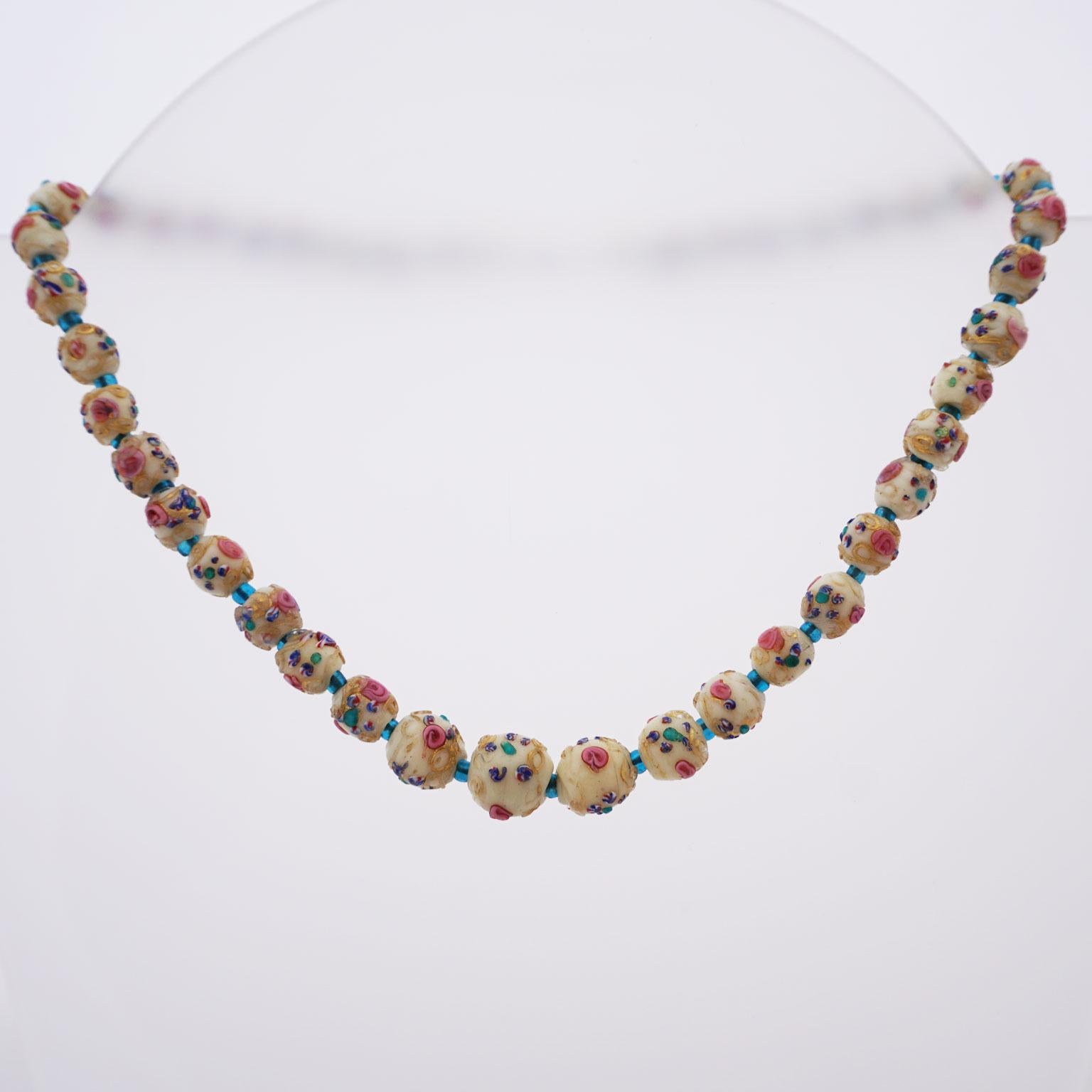 Murano necklace Millefiori around 1910

Necklace in the handcrafted style of the Millefiori (1000 flowers). Various naps and thread elements have been applied to opaque base pearls and fused so that a colourful flower pattern is associated. This