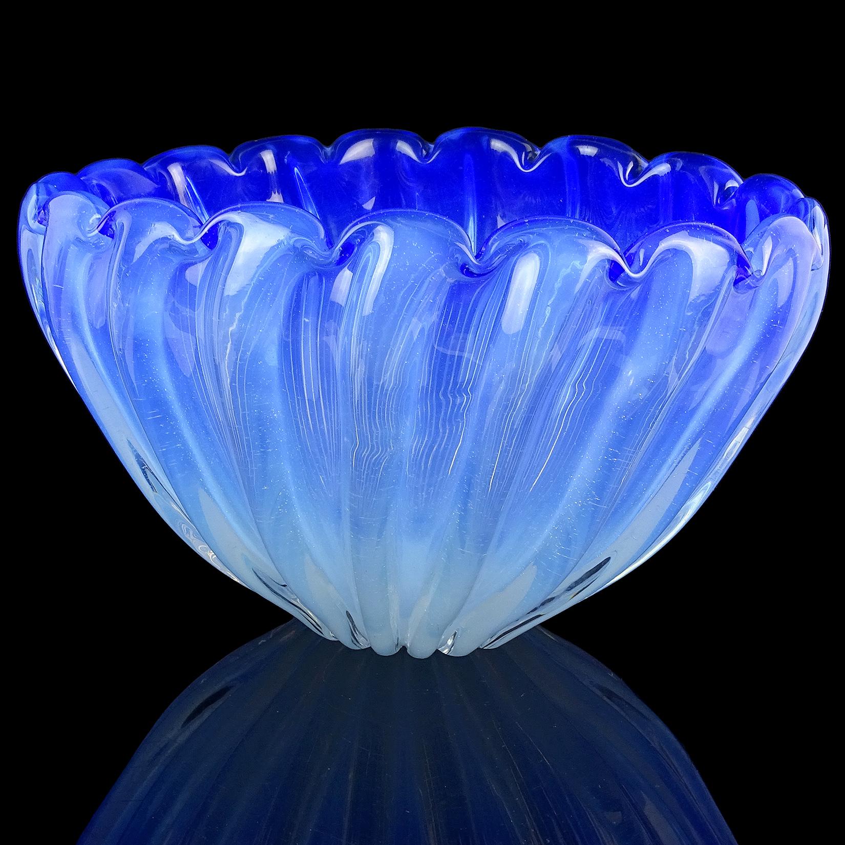 Beautiful and large, vintage Murano hand blown opalescent blue and white Italian art glass centerpiece bowl / vase. The piece has a scalloped rim, with a ribbed design throughout the body. It is a fairly tall piece at 5 1/2