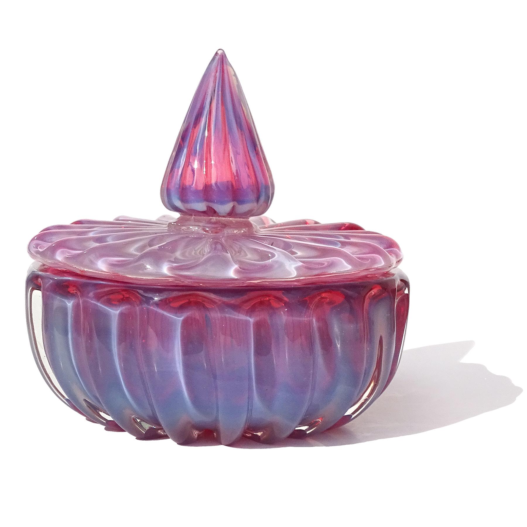 Beautiful vintage Murano hand blown opalescent pink and bluish white outer layer Italian art glass vanity jewelry box / powder jar. Created in the manner of the Barovier e Toso and Seguso Vetri d'Arte companies. The surface of the jar has a ribbed