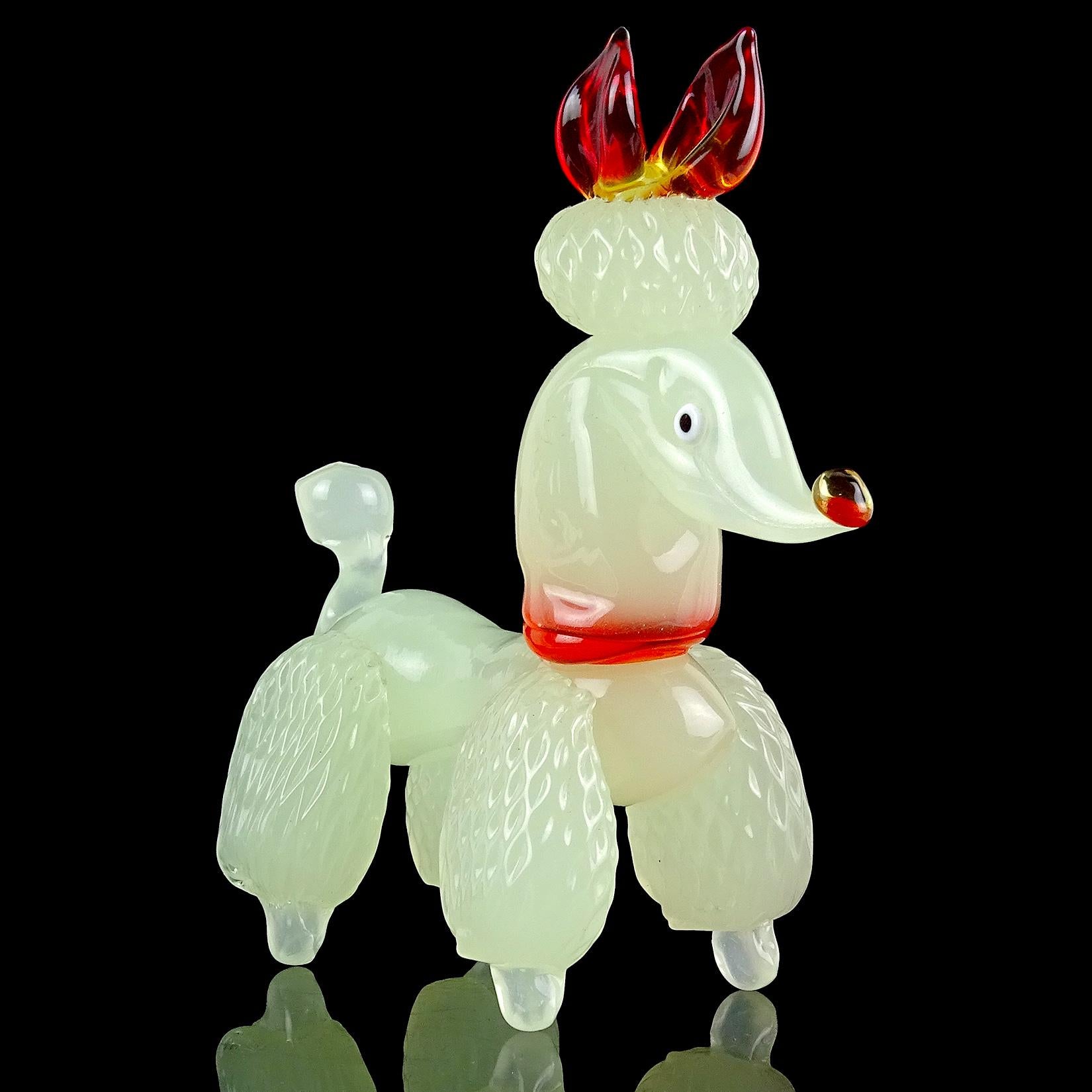 Very cute Murano hand blown opalescent creamy white Italian art glass poodle puppy dog figurine. It has been well groomed, with pompoms on its legs, tail and top of the head. The applied collar and bow have a red orange color, with some yellow as