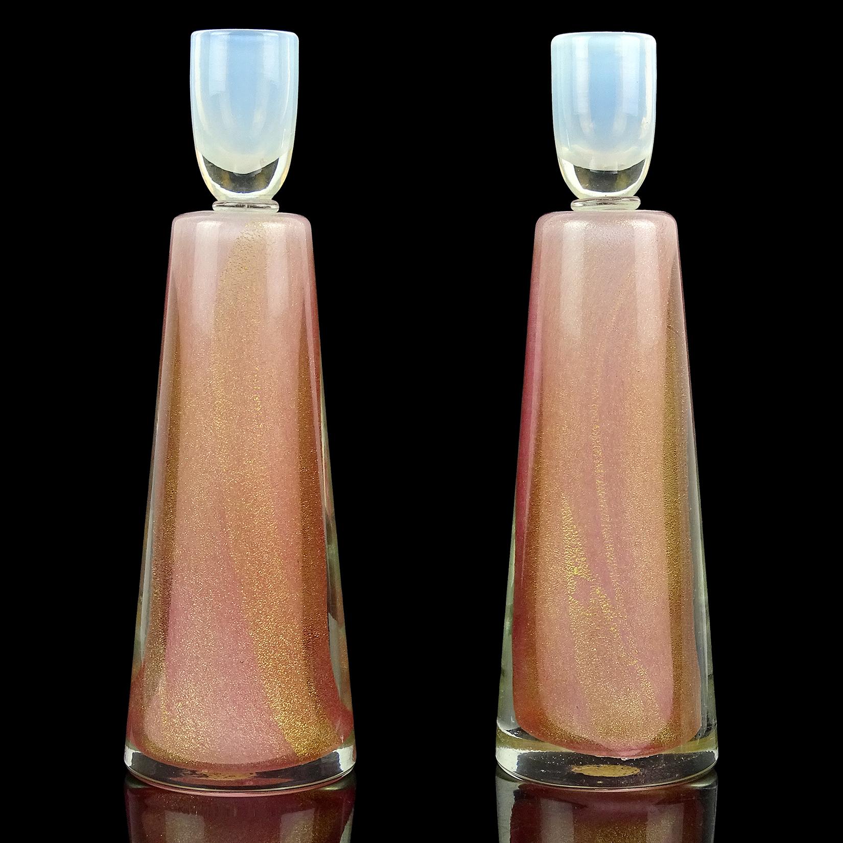 Beautiful pair of vintage Murano hand blown Sommerso pink, white opalescent and gold flecks Italian art glass candlesticks. Documented to the Fratelli Toso company. The candleholders at the top are opal white and clear glass. The bodies have a thick