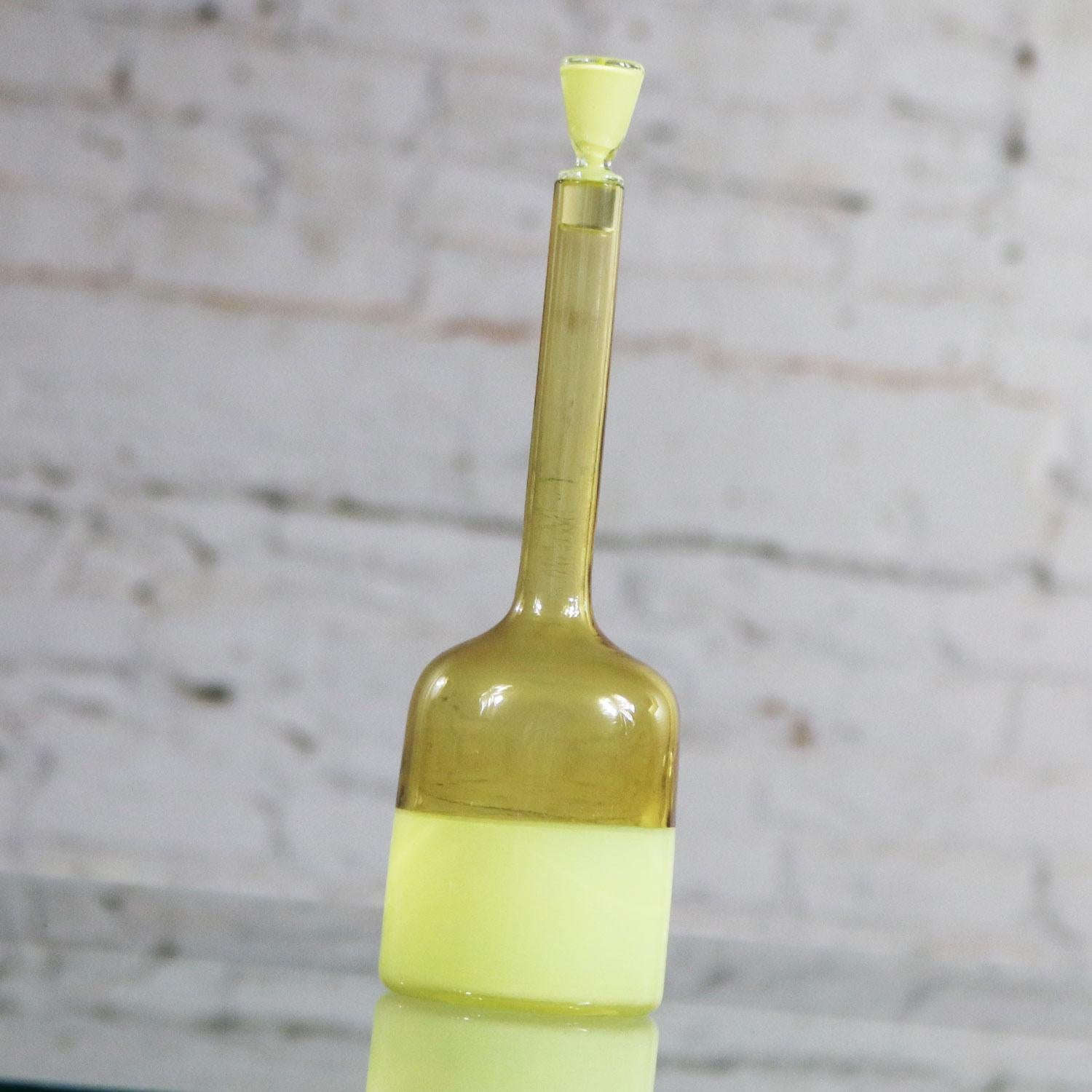 Fabulous Murano bottle and stopper in yellow opaque and clear amber incalmo glass. It is attributed to Gio Ponti for Venini although unsigned. This bottle is in incredible vintage condition with no chip, crack, or chigger. It does have a small