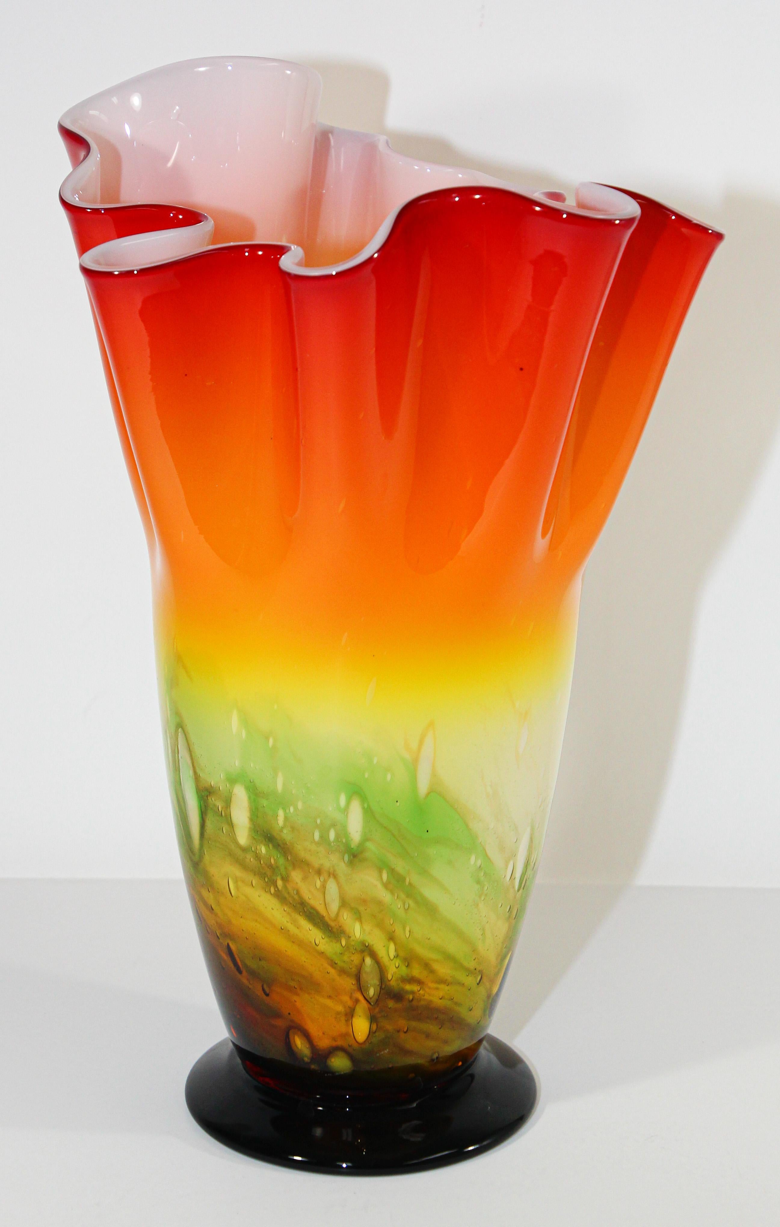Gorgeous mid-20th century Italian Murano Venetian Fulvio Bianconi style hand blown bright orange art glass decorative Fazzoletto handkerchief footed vase.
Sculptural exquisite vase in organic form with bright orange, green and yellow colors with