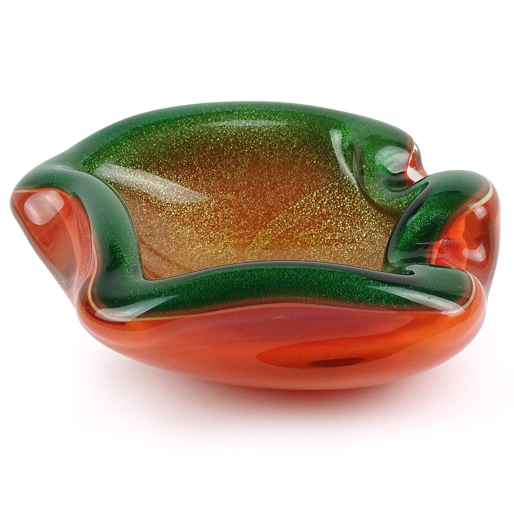 Beautiful vintage Murano handblown bright orange with green rim and gold flecks Italian art glass bowl. Created in the manner of designer Alfredo Barbini. Very unusual color combination, with Ombre style fade of color and biomorphic shape. Profusely