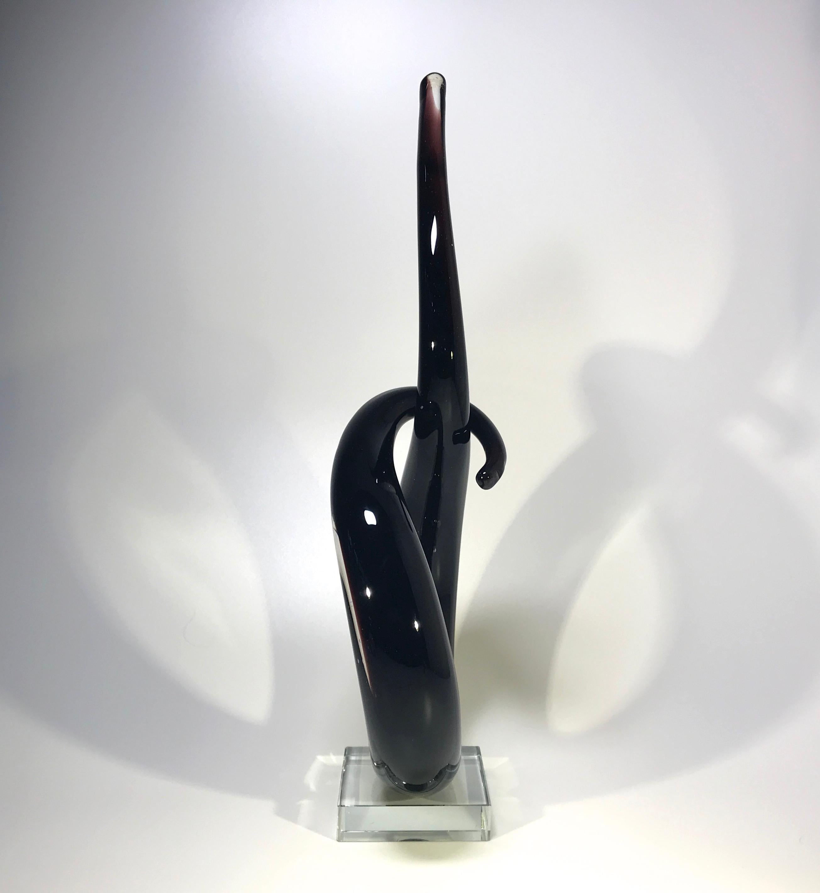 Abstract oxblood black Murano of Italy, sculpture from the 1960s
A fabulous piece of entwined Murano
Stands on a clear square plinth
circa 1960s
Measures: Height 15 inch, width 6.5 inch, depth 3 inch
Very good condition., very light scratches