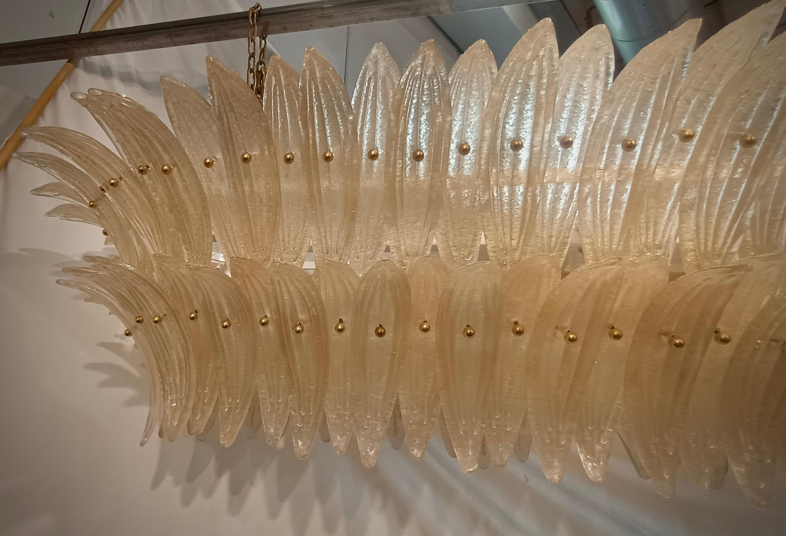 Fantastic Murano chandelier with an elongated design and brass structure. Note the shape of the palmette leaves that it is completely composed of.

Murano chandelier in artistic glass and brass. Made with an ovoid structure, to which curved crescent