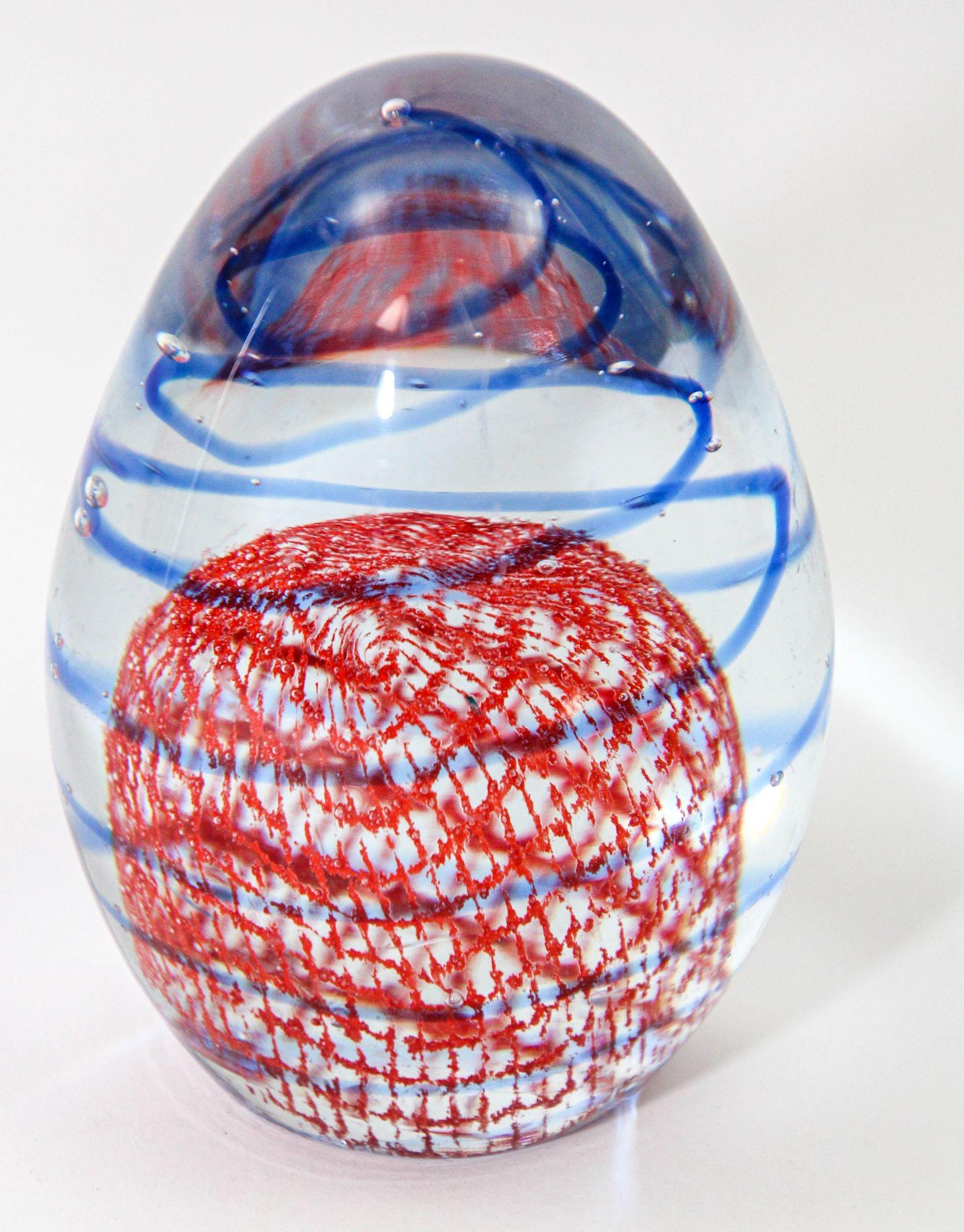 Murano Paperweight Blue Red Ribbons Controlled Bubbles Italian Art Glass Egg Shape.
Orange and Blue Art Glass Sphere Paperweight Decorative Object.
A very beautiful orange and blue ribbon art glass paperweight decorative blown crystal glass