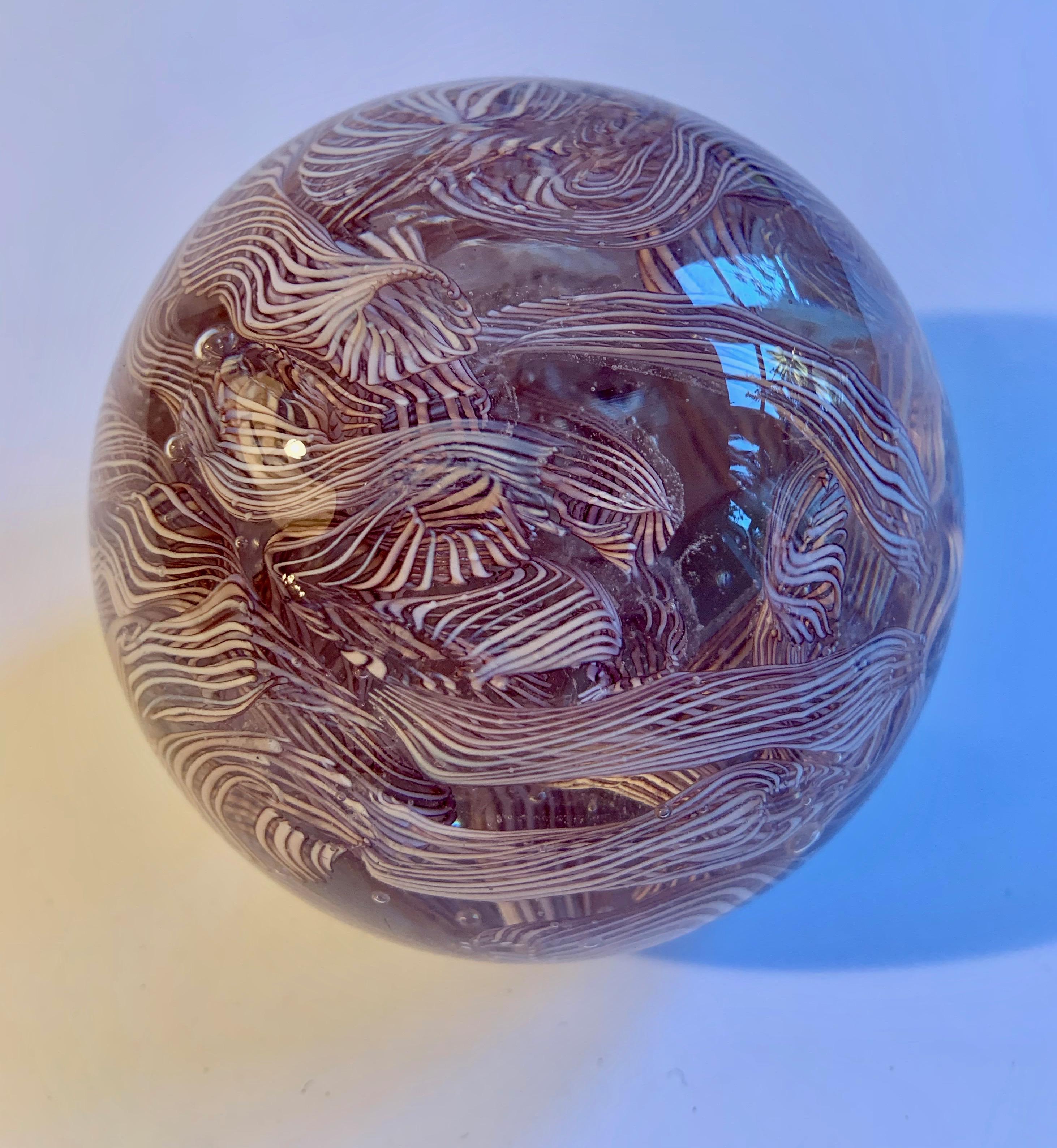 An intricate and lovely multi-ribbon detailed glass sphere. A wonderful decorative paperweight