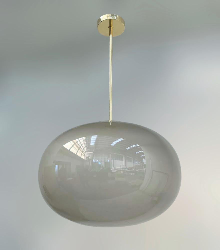 Italian pendant with a large light frosted smoky Murano pebble glass shade mounted on brass frame / designed by Fabio Bergomi for Fabio Ltd / Made in Italy
Measures: Diameter 23.5 inches, height 35.5 inches including rod and canopy
1 light / E26 or