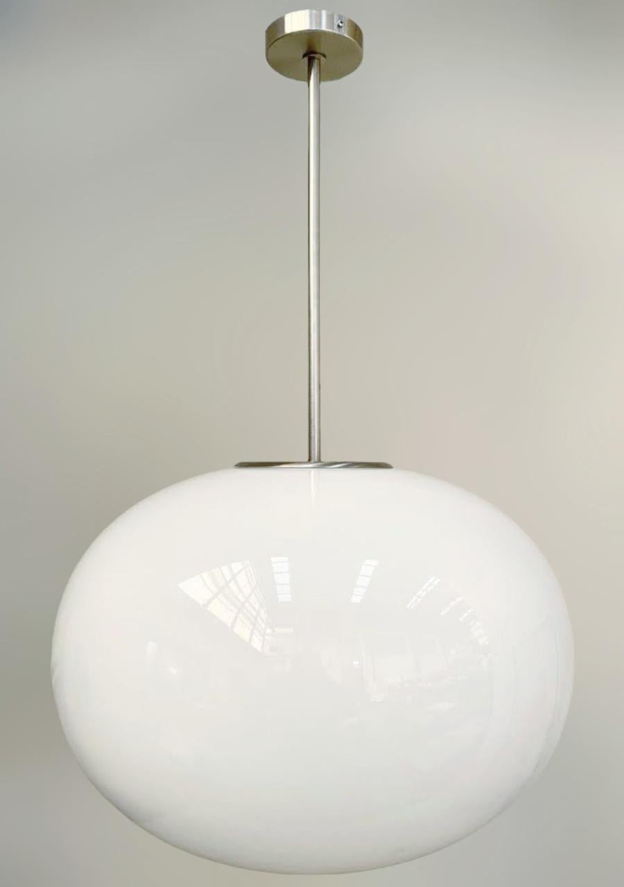 Italian pendant with a large glossy white Murano pebble glass shade mounted on brass frame / designed by Fabio Bergomi for Fabio Ltd / Made in Italy
Measures: Diameter 23.5 inches, height 35.5 inches including rod and canopy
1 light / E26 or E27