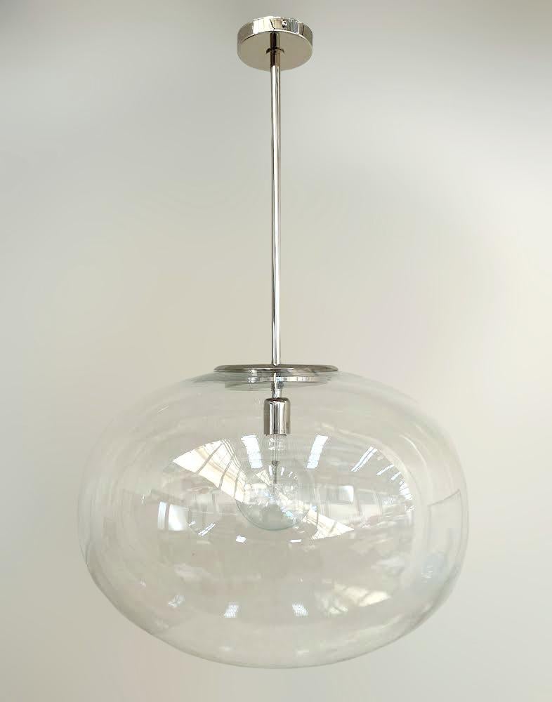 Italian pendant with a large clear Murano pebble glass shade mounted on brass frame / designed by Fabio Bergomi for Fabio Ltd / Made in Italy
Measures: Diameter 23.5 inches, height 35.5 inches including rod and canopy
1 light / E26 or E27 type / max