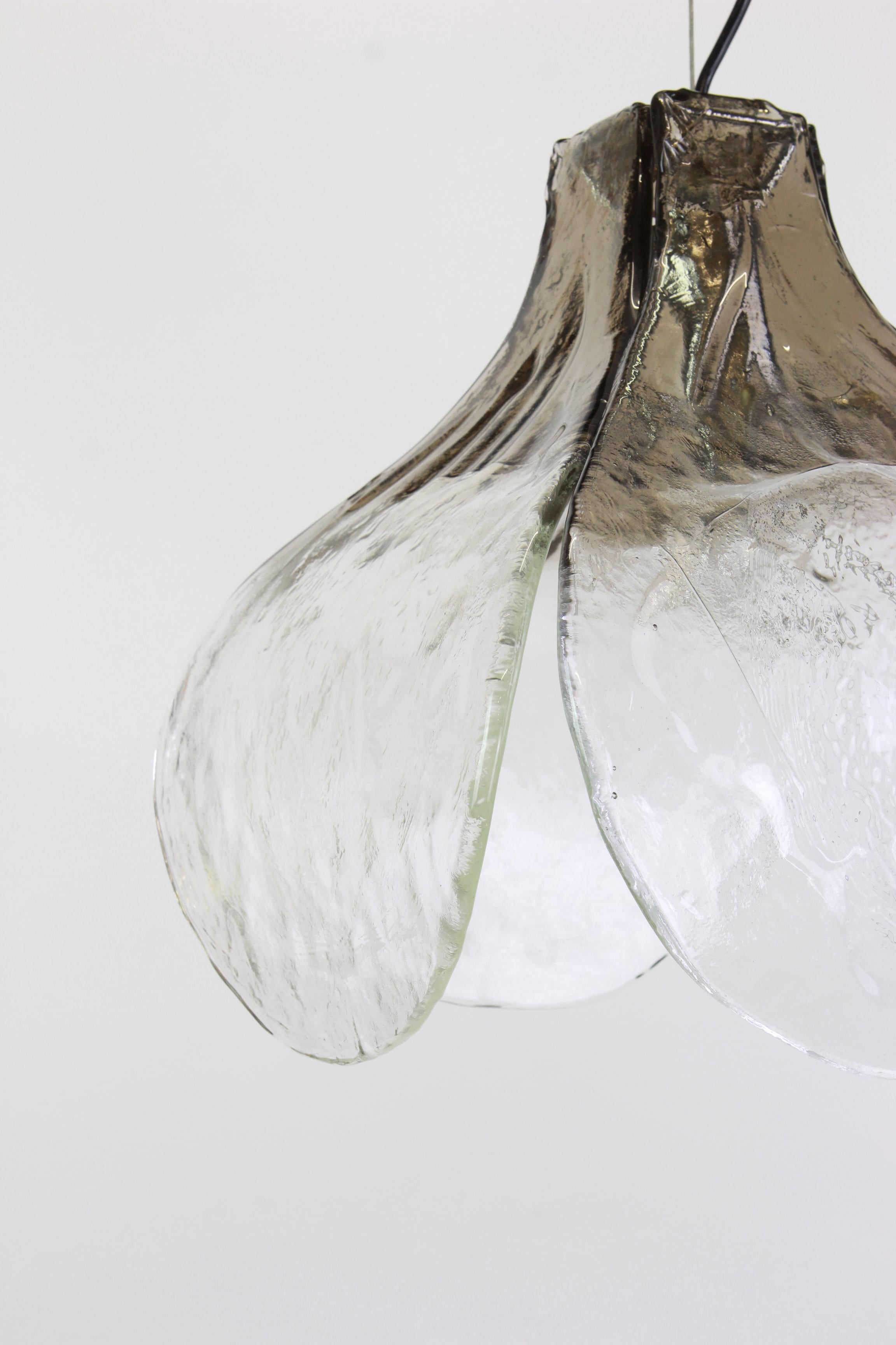 Murano pendant light designed by Carlo Nason for Mazzega, 1970s

A wonderful floral pendant light with four large hand blown clear and smoked Murano glass petals which are supported by a metal frame, designed by Carlo Nason for Mazzega,