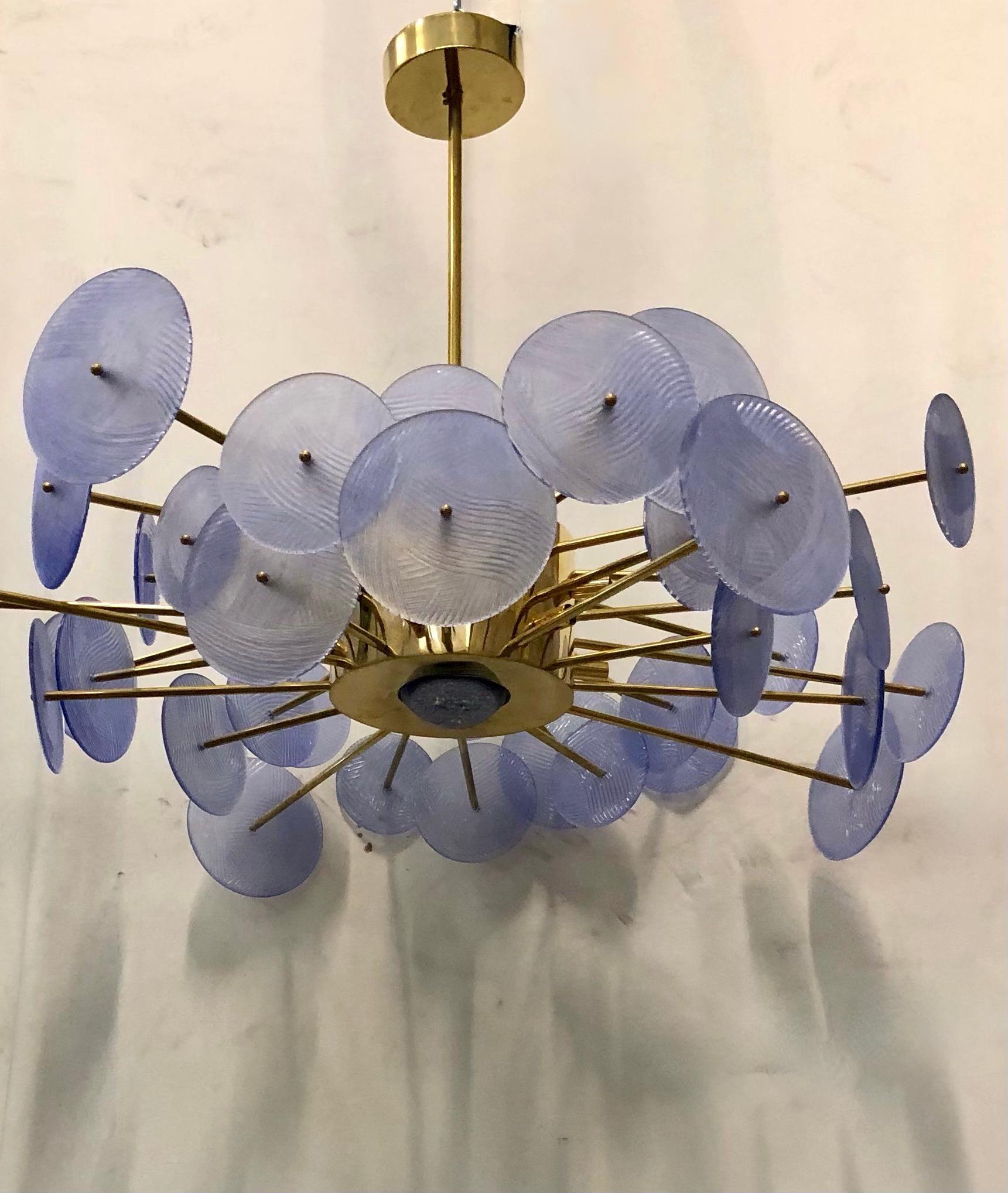 Besonderer runder Sputnik mit Messingstruktur und Scheiben aus Murano-Glas. Es sieht aus wie ein System von Planeten, die kreisförmig gravitieren. Das Design mit dem großen zentralen Messingkörper ist sehr schön.

Kronleuchter mit einer Struktur aus