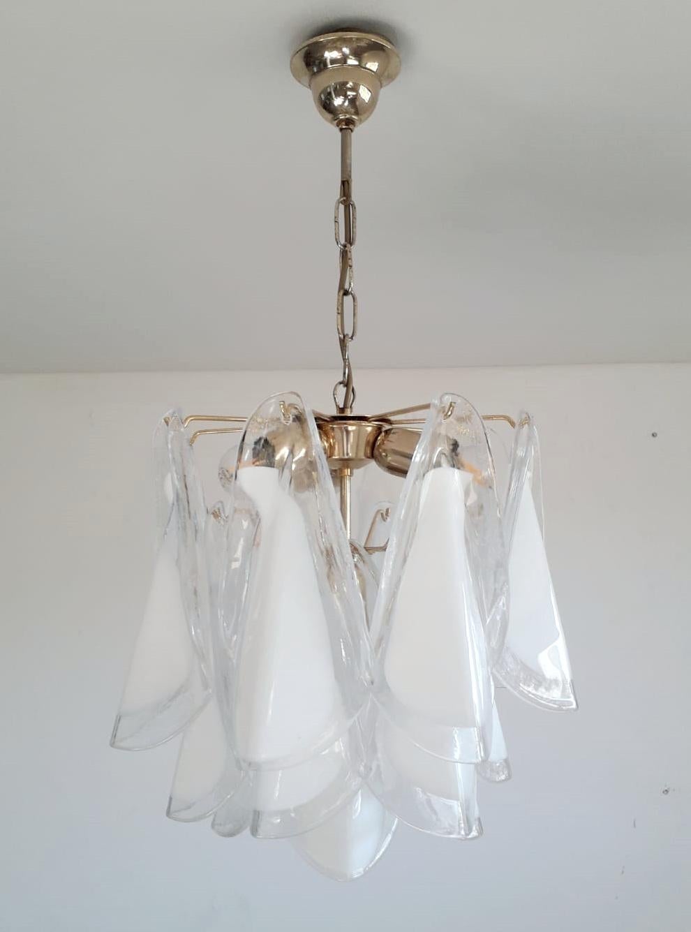 Vintage Italian chandelier with milky white Murano glass petals suspended on brass frame / Made in Italy by Mazzega, circa 1960s
Measures: diameter 16 inches, chandelier height 16 inches, total height 27.5 inches including chain and canopy
4 lights